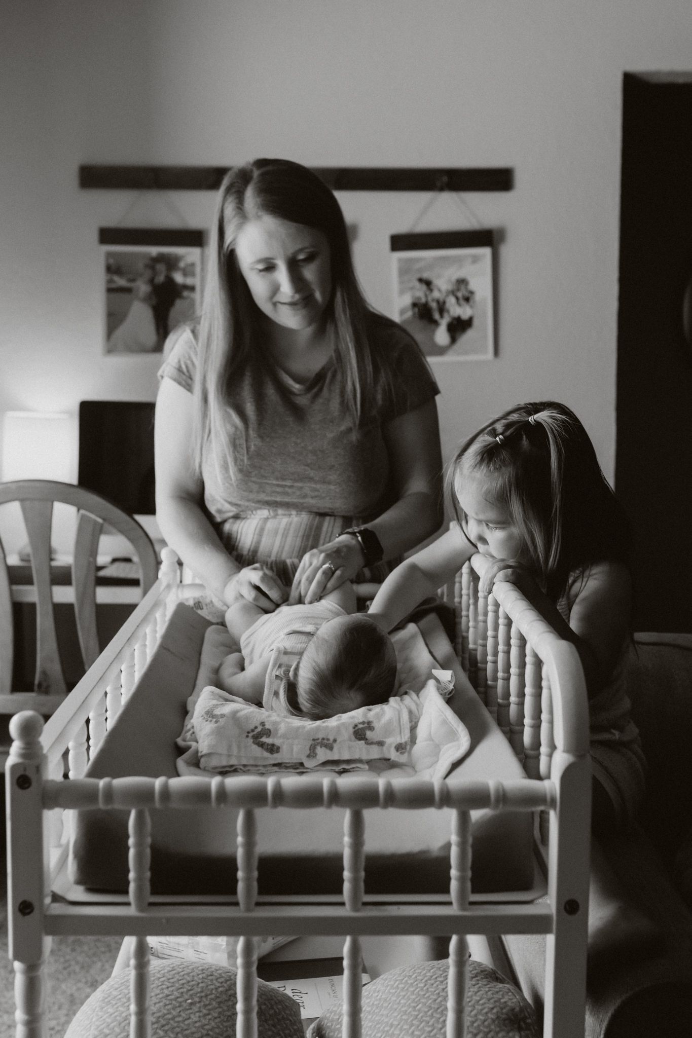 A series of black and white photos show a baby receiving physical therapy exercises on a small wooden bench.