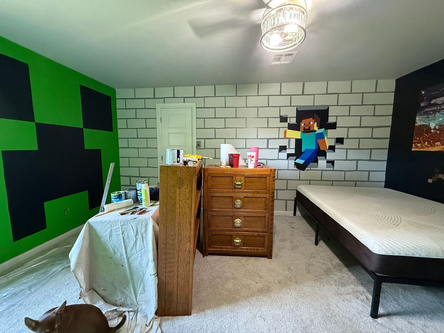 Gaming themed bedroom with Minecraft-style wall decor, white subway tile accent wall, and wooden dresser. In-Home Photography Liz Perez