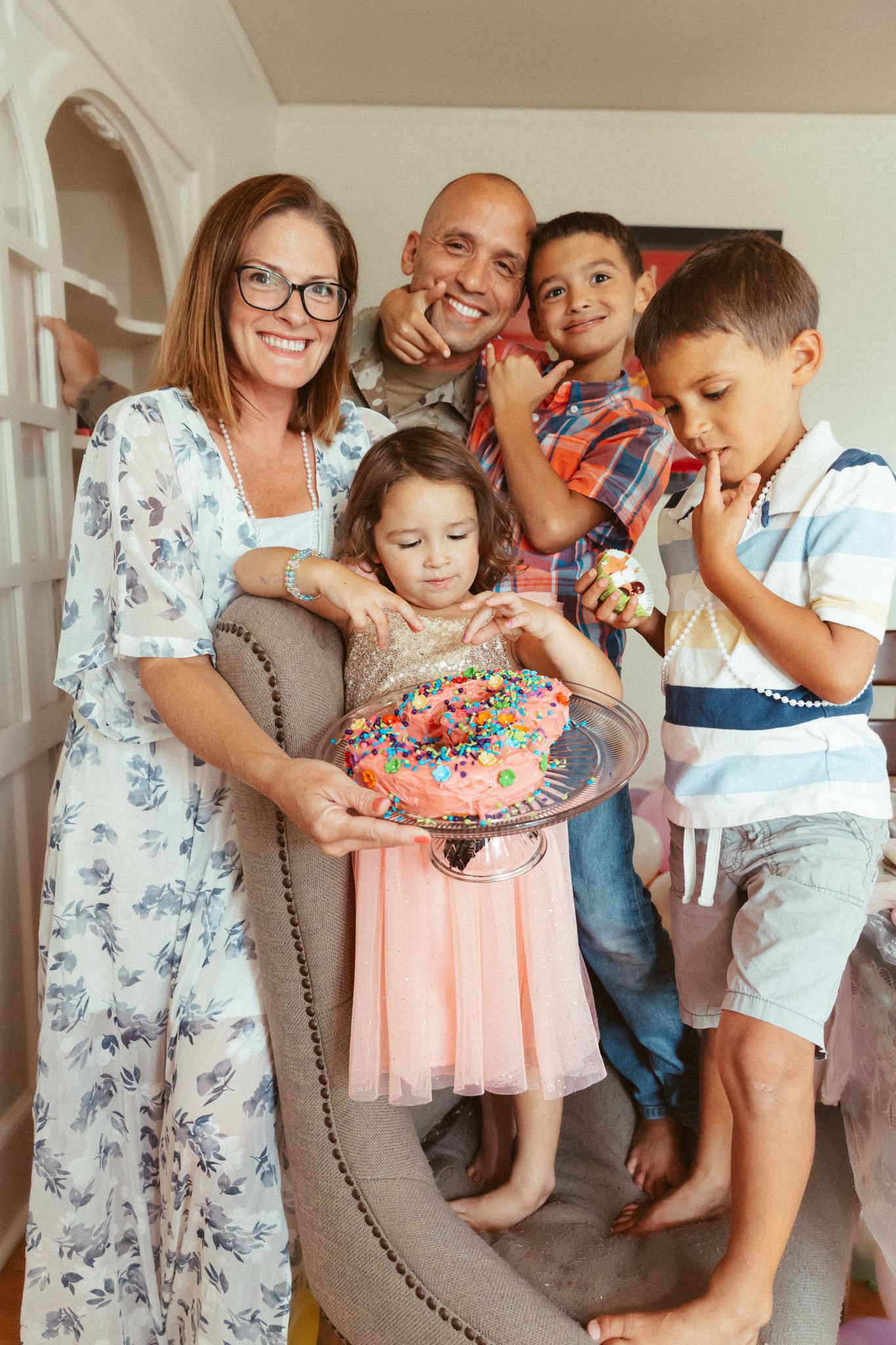 A celebration with cake and laughter in a bright indoor setting.