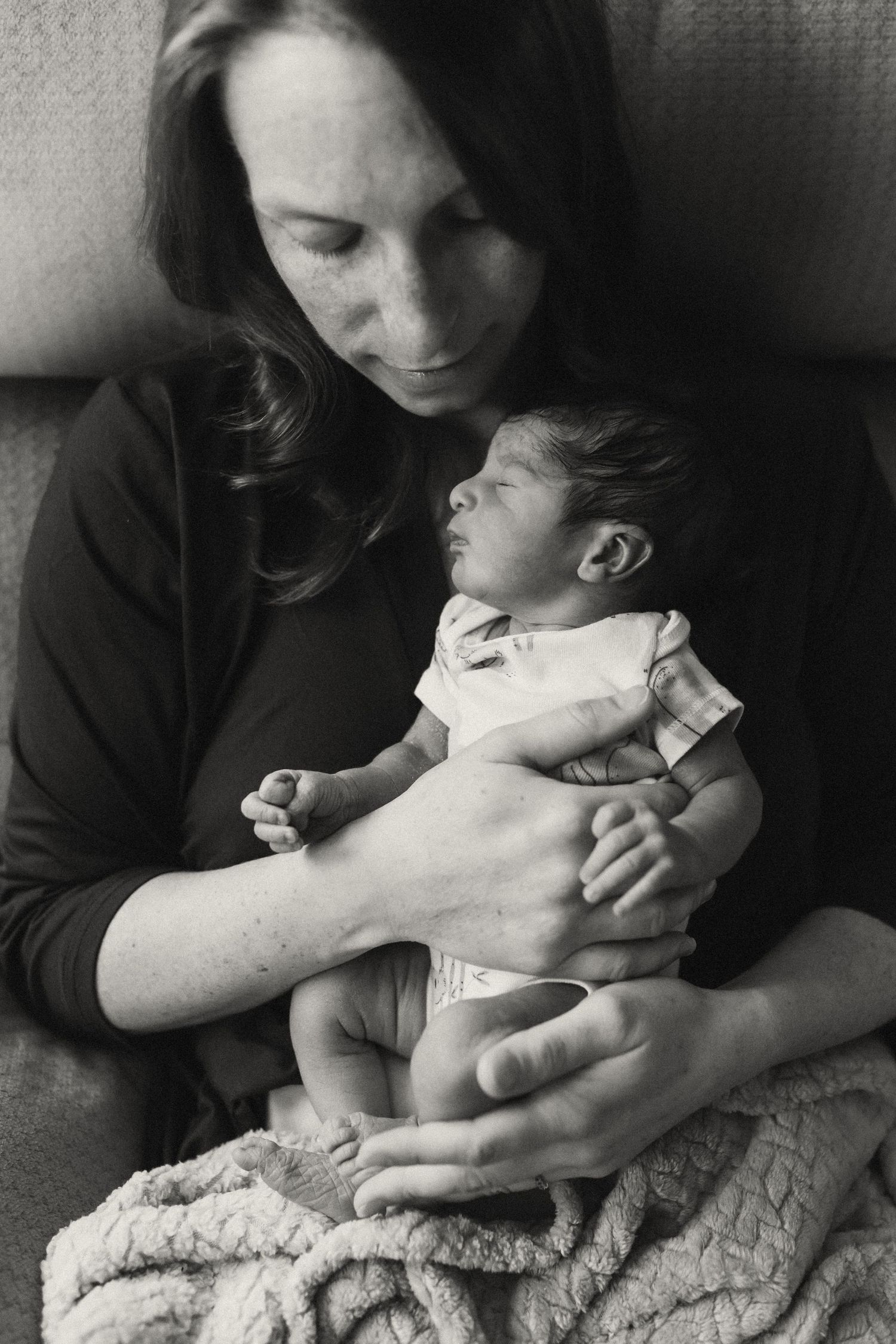 Black and white intimate portrait with soft shadows and gentle moments.