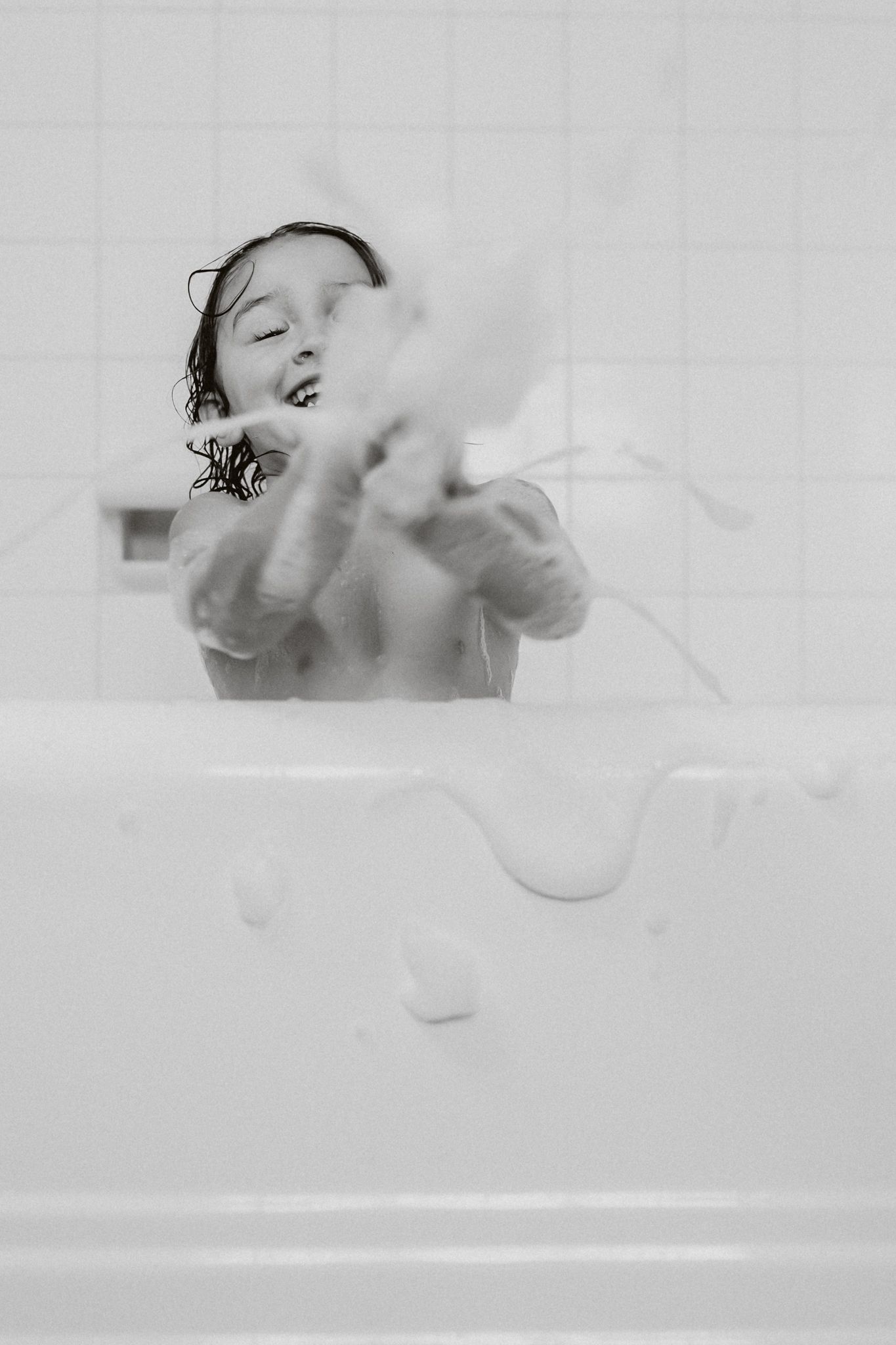 Artistic black and white bathtub photography sequence showing water splashing and childhood photography moment I don't want to miss.