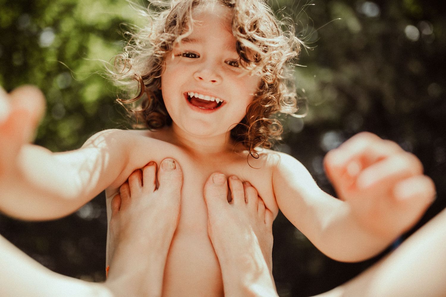 Sun-drenched outdoor portraits capturing joyful expressions and laughter.