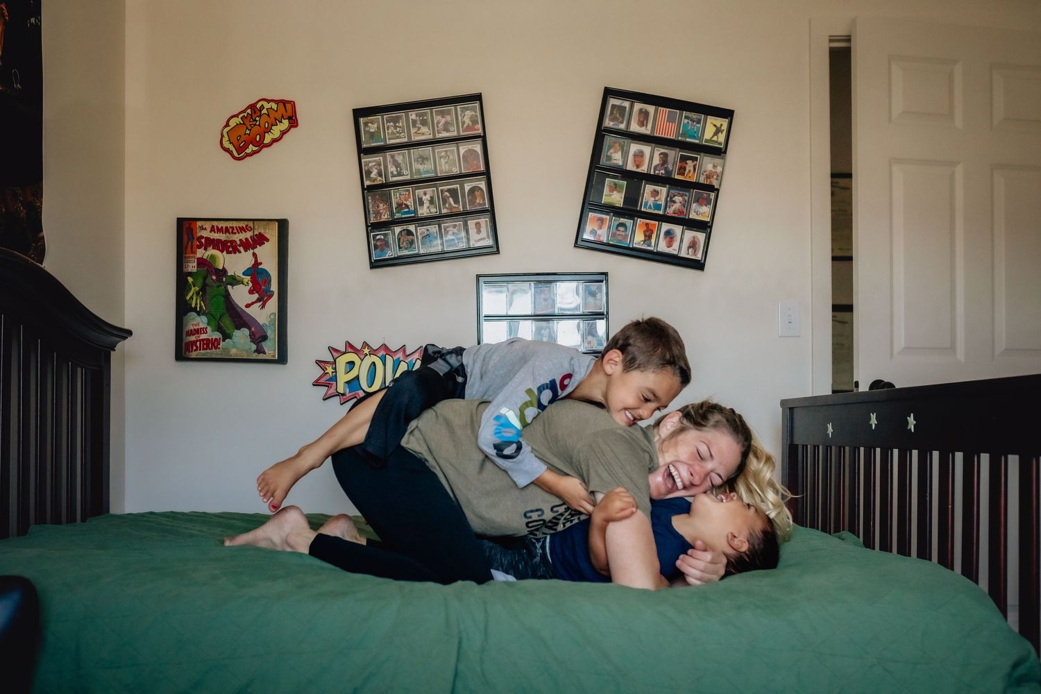 Lawton, Oklahoma Documentary family photographer Liz Perez in the frame with her two sons wrestling by using the interval timer on the DSLR.