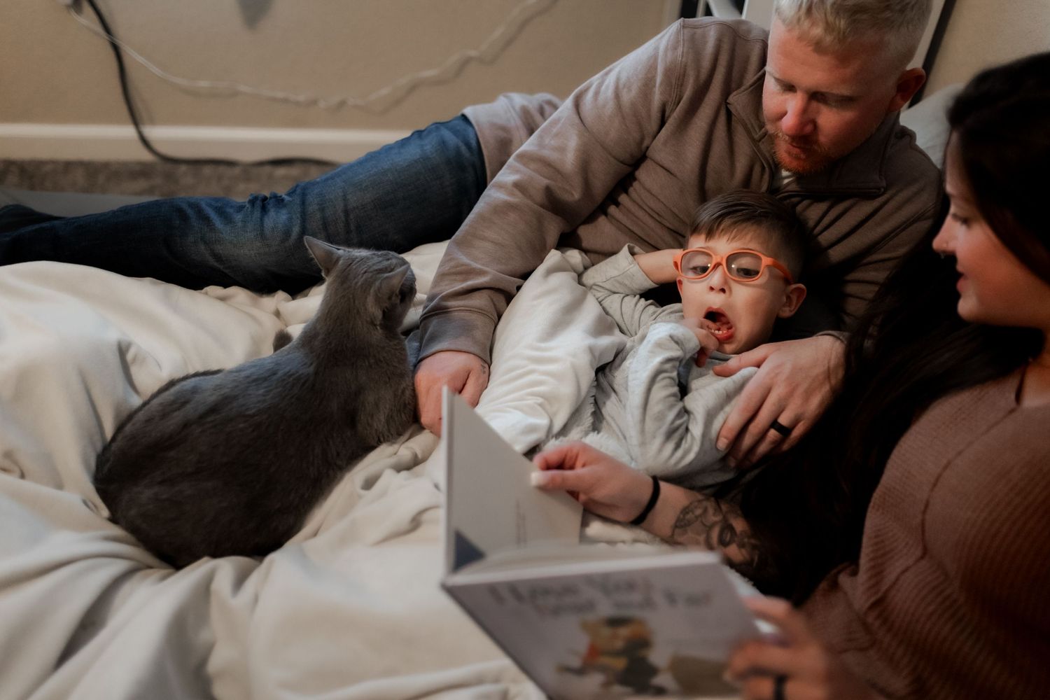 Parent and child sharing an intimate bedtime moment under cozy blankets.