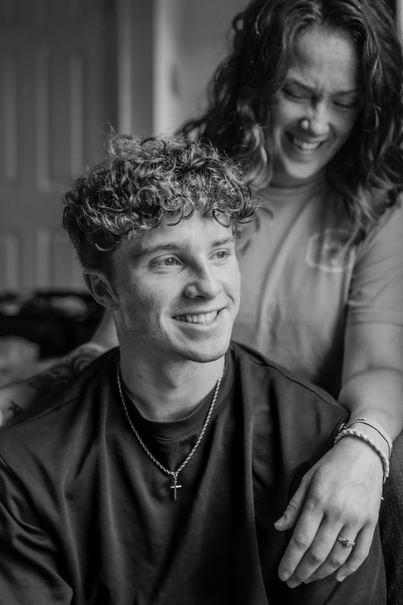A black and white candid portrait showing shared laughter and joy between two people. In-Home Photography Liz Perez