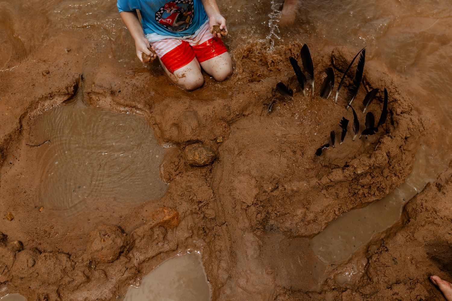 Overhead view of sand formations and patterns made by children playing at beach.