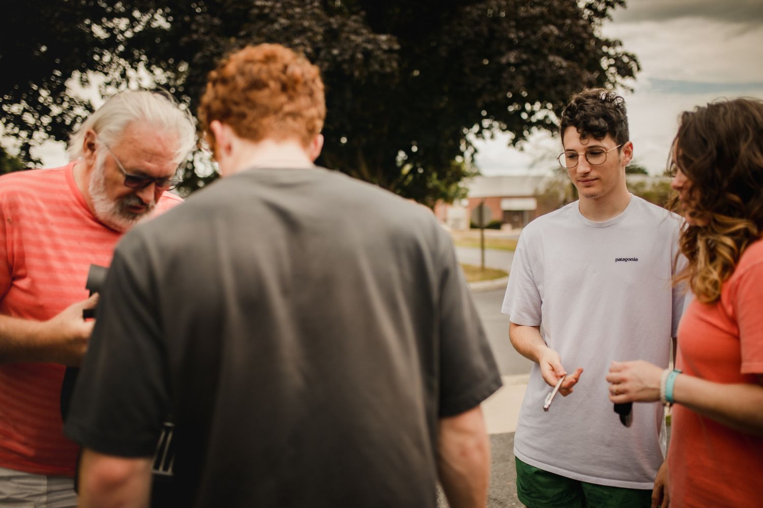 People standing together in casual clothing outdoors on a sunny day.In-Home Photography Liz Perez