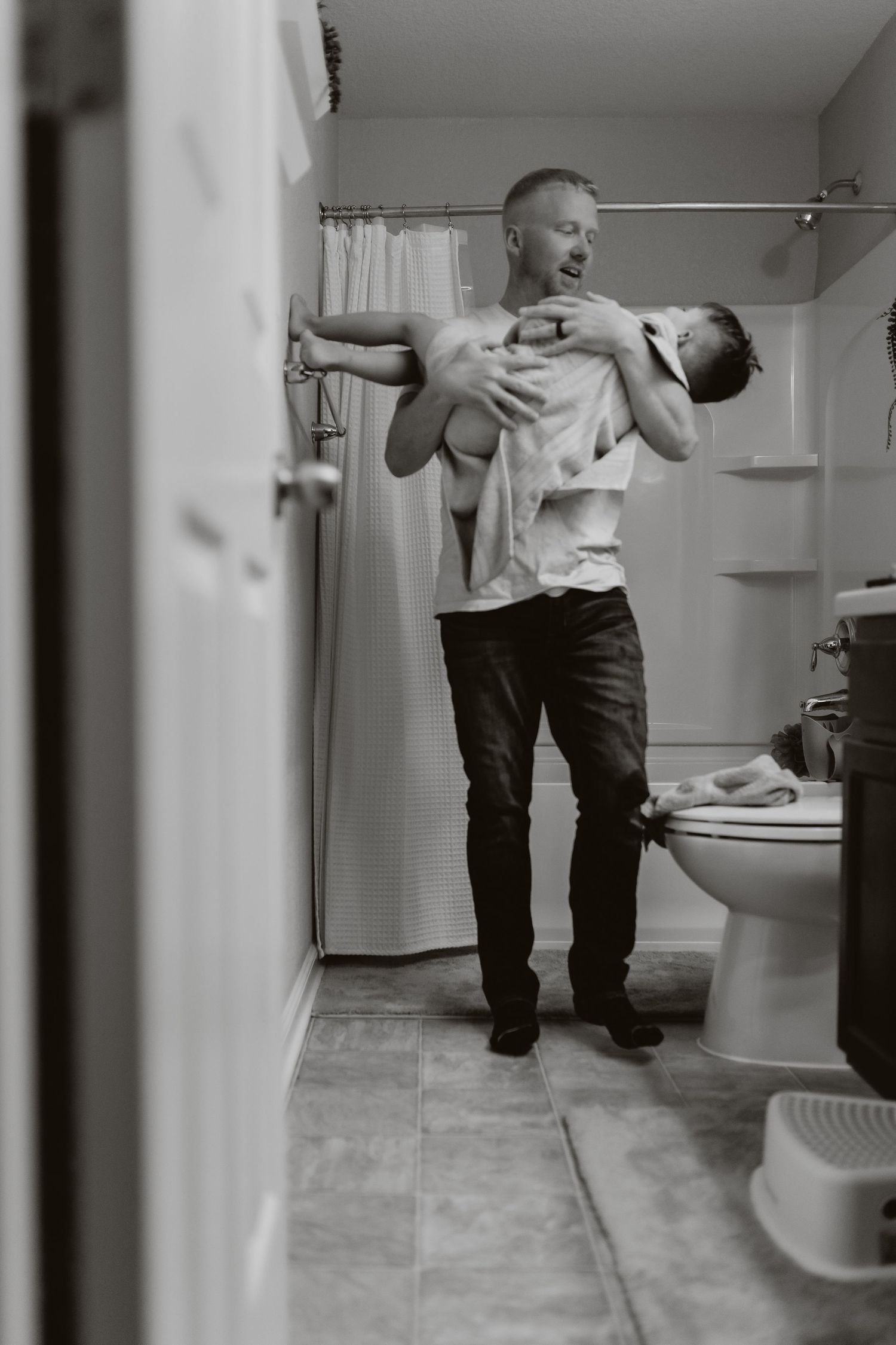 Black and white bathroom scene showing playful movement and motion.