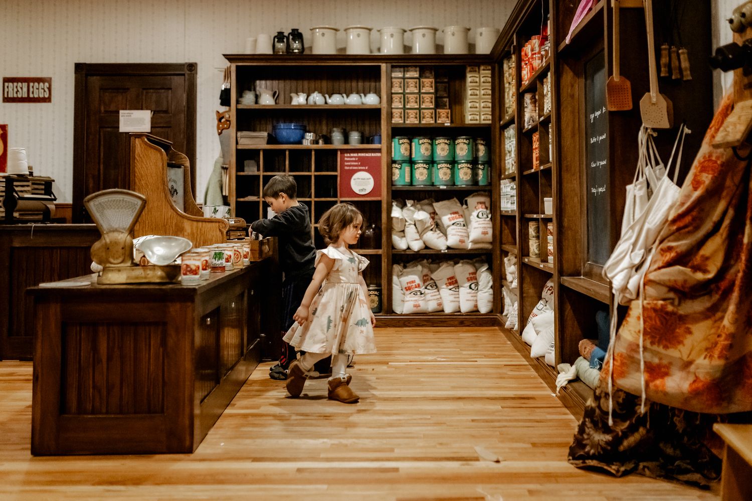 Interior view of an old-fashioned general store with wooden shelving and vintage merchandise.