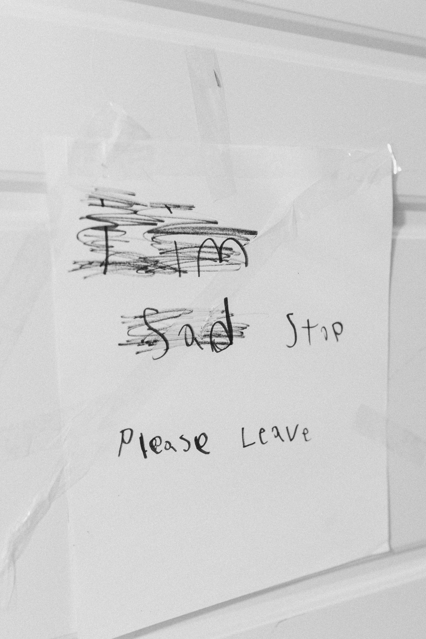 Series of childlike handwritten notes and scribbles on white paper.