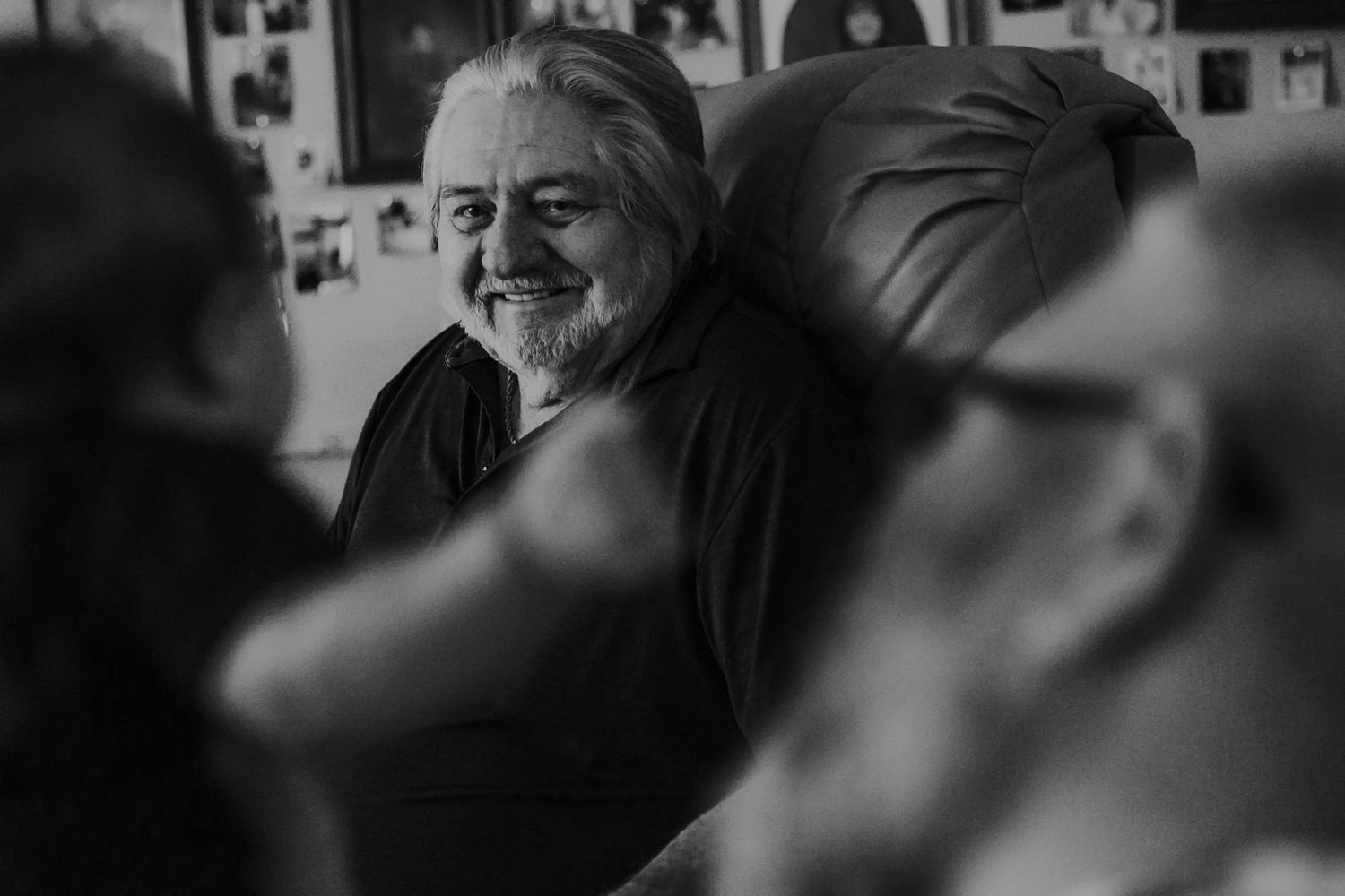 A candid black and white shot showing laughter and joy indoors.