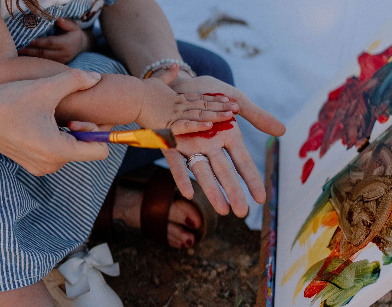 toddler gives mom a high five during the mom and me paint mini session in knob noster