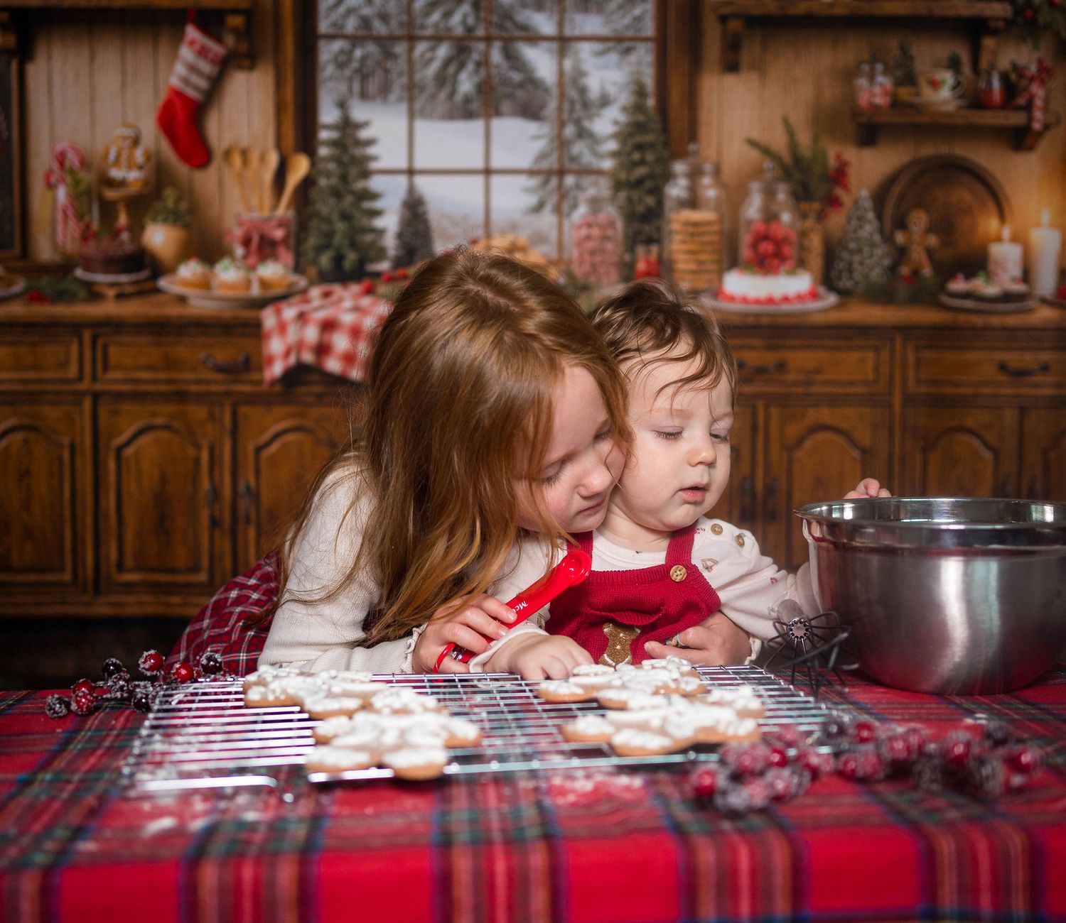 A sister and brother decorate cookies during a holiday baking photo session located in the photographer's studio in Warrensburg