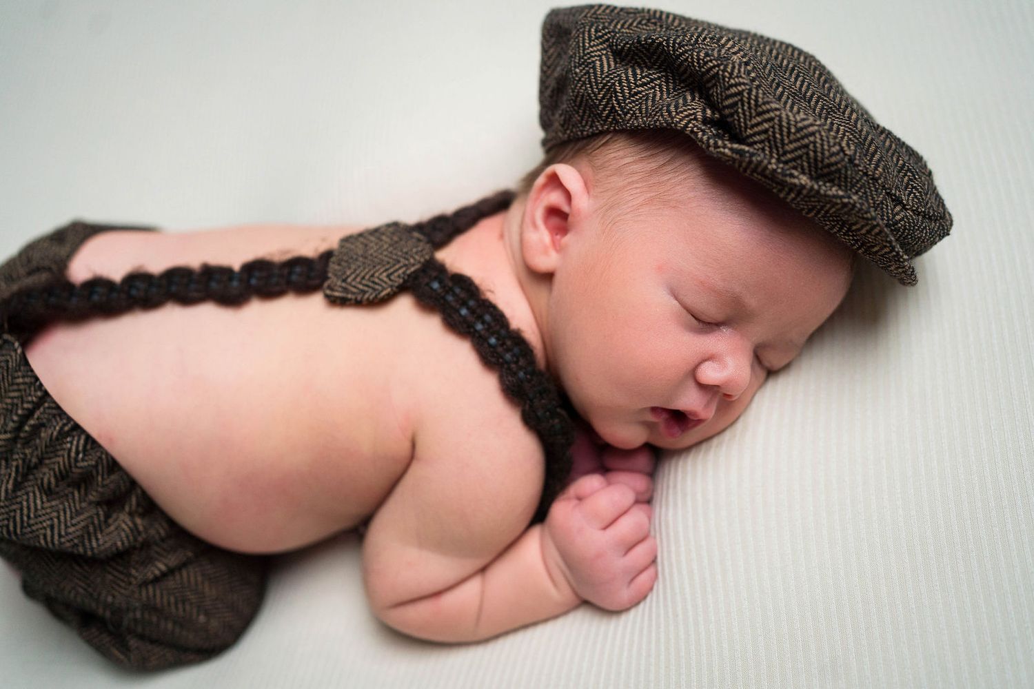 a baby falls asleep during session in Lee's summit during his newborn photoshoot