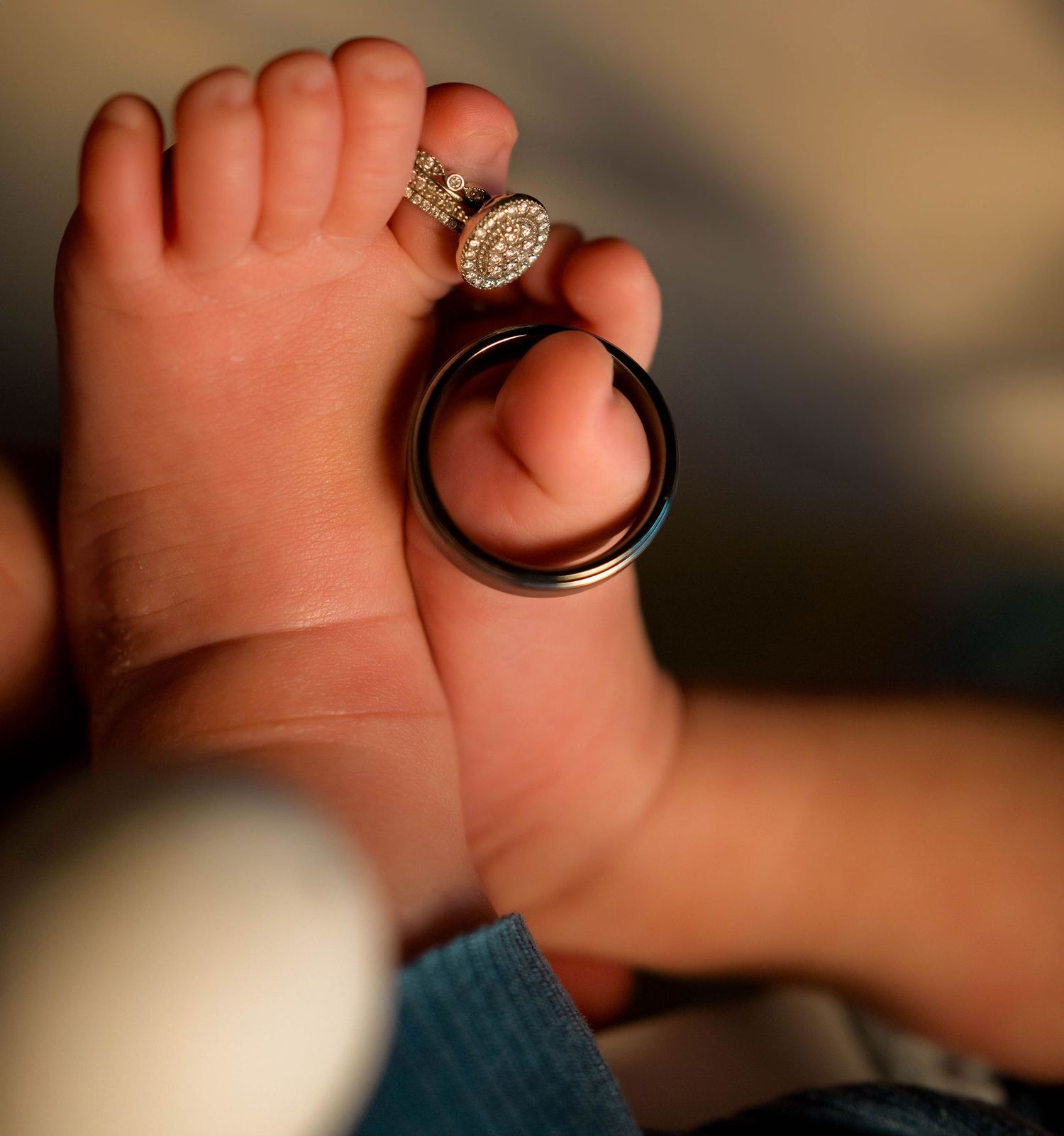 close up of wedding rings during a newborn session in an in-home session in Kansas City, MO