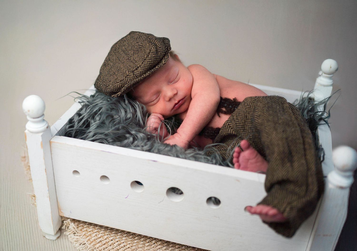 A baby cuddles a pillow during his session in Kansas City, MO