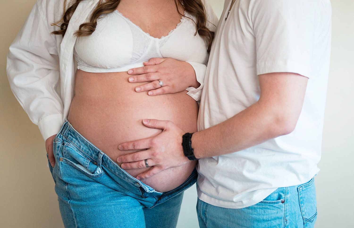 A couple poses together in studio in Warrensburg for their maternity session