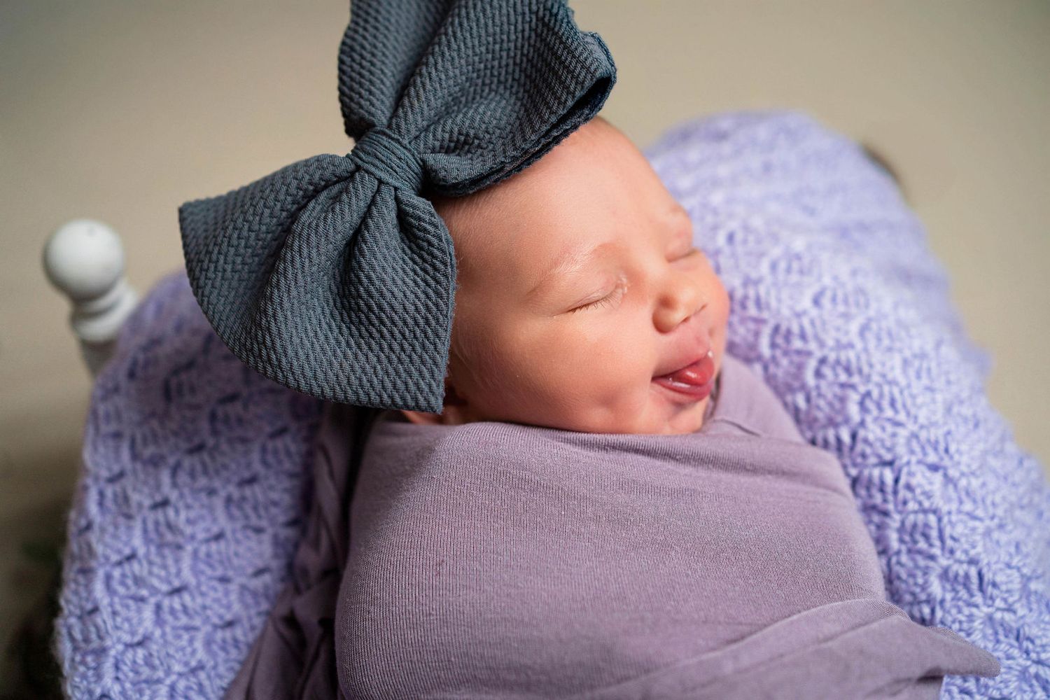 Baby sticking her tongue out during her portrait session in Lee's Summit, Missouri for her newborn photography session.