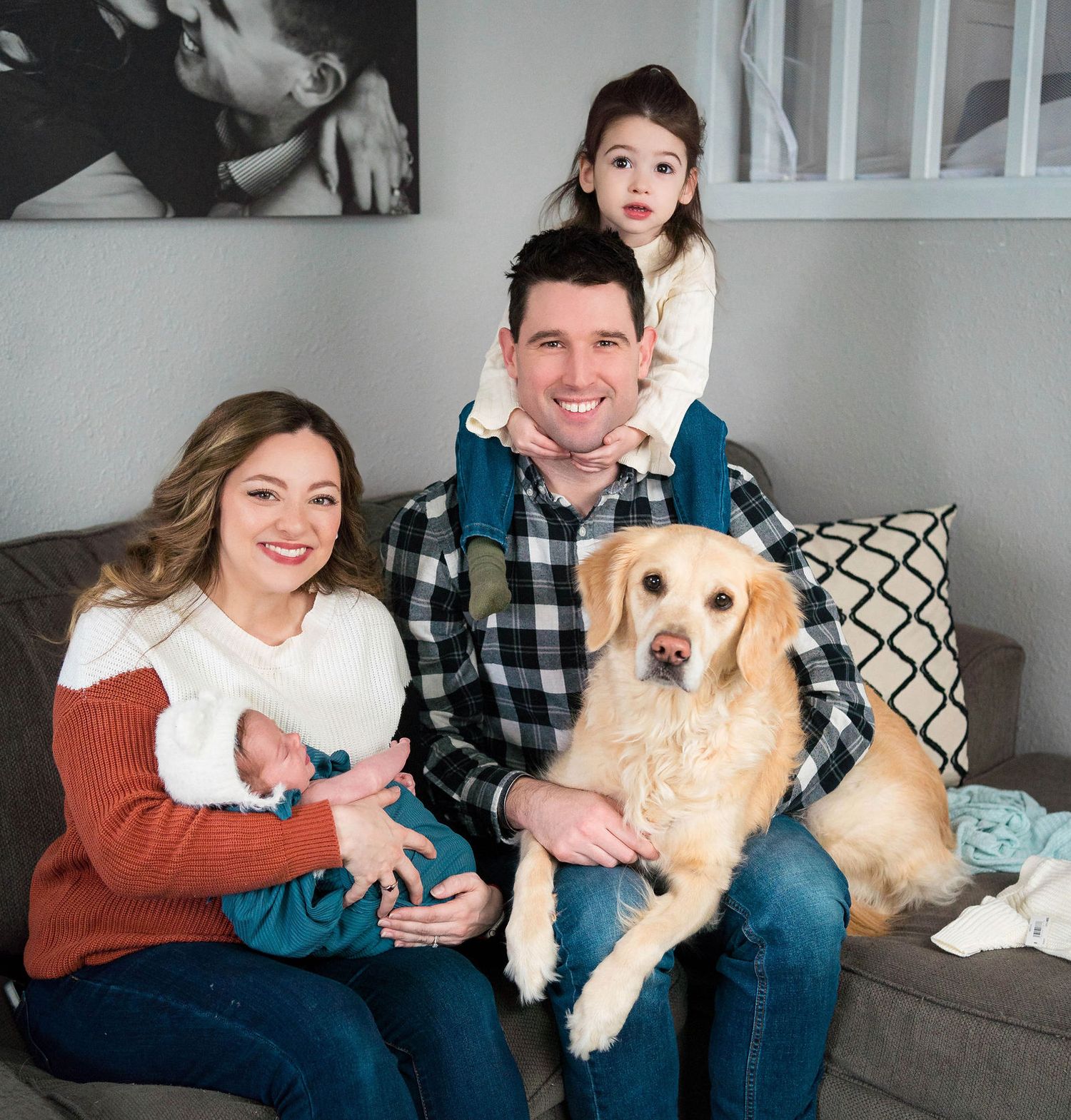 Family and their family dog poses for the camera during an in home family newborn photoshoot in Lee's Summit