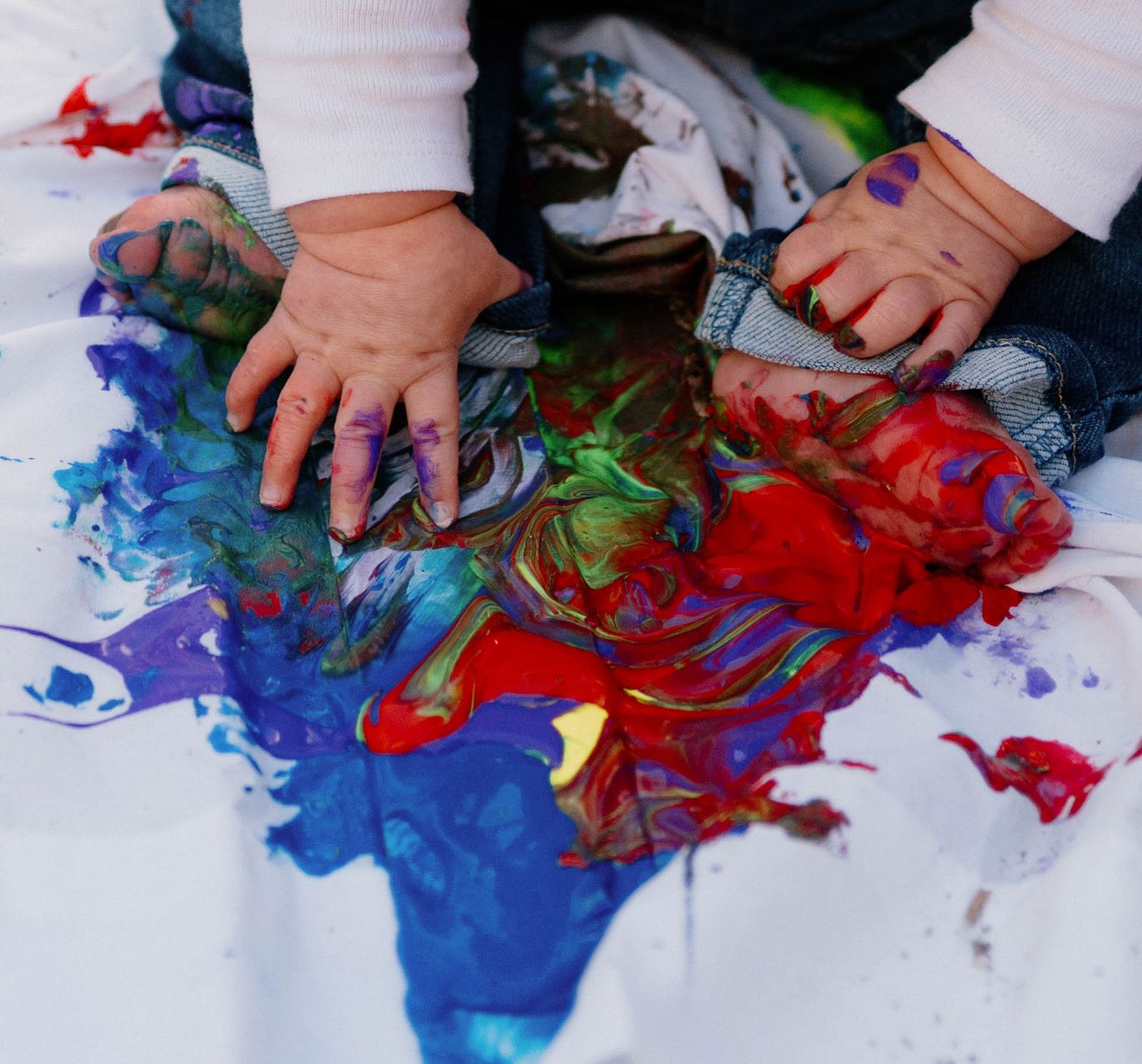 a baby plays in the paint during her mini photoshoot with her mom in warrensburg