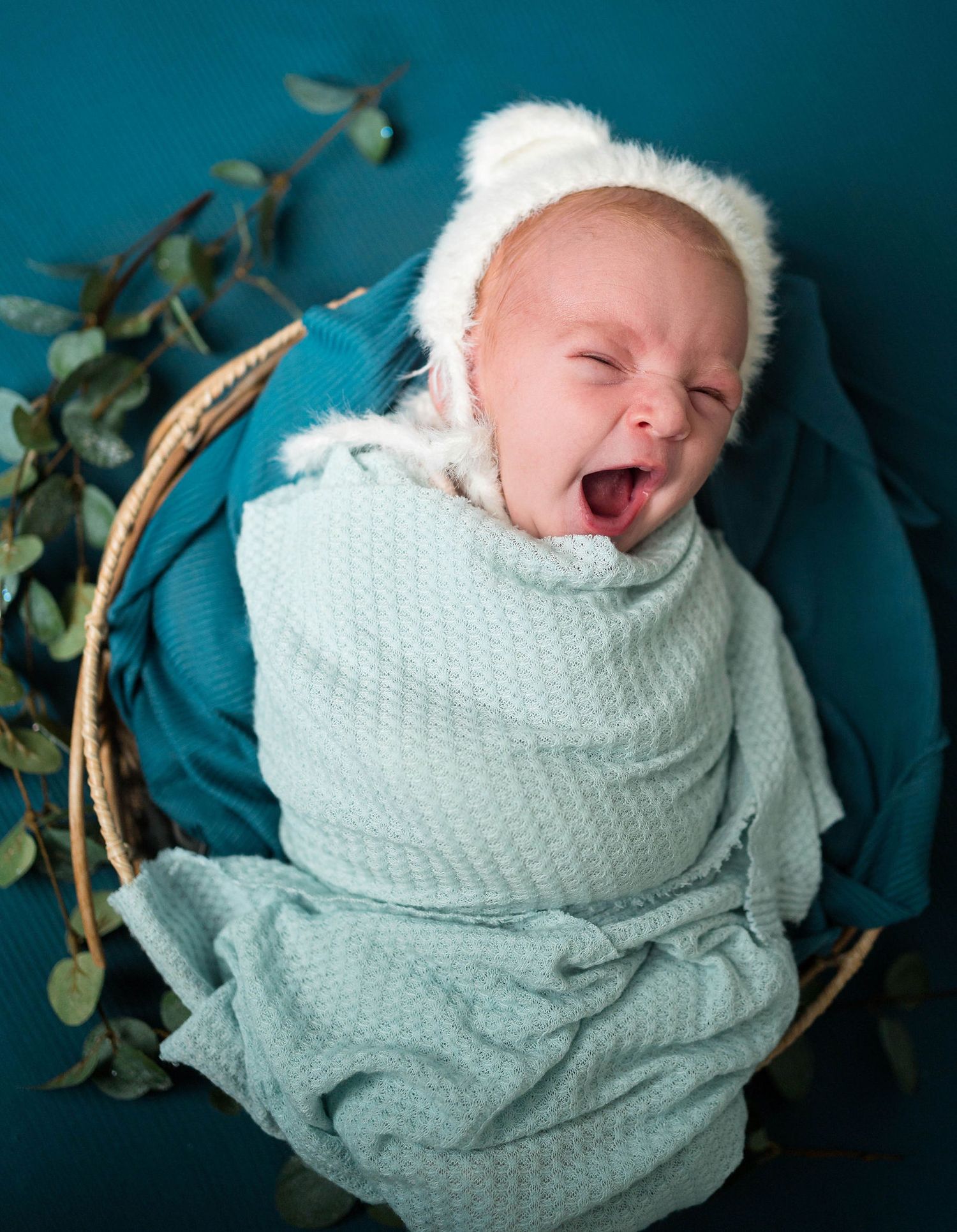 A baby yawning during their newborn session in Warrensburg session