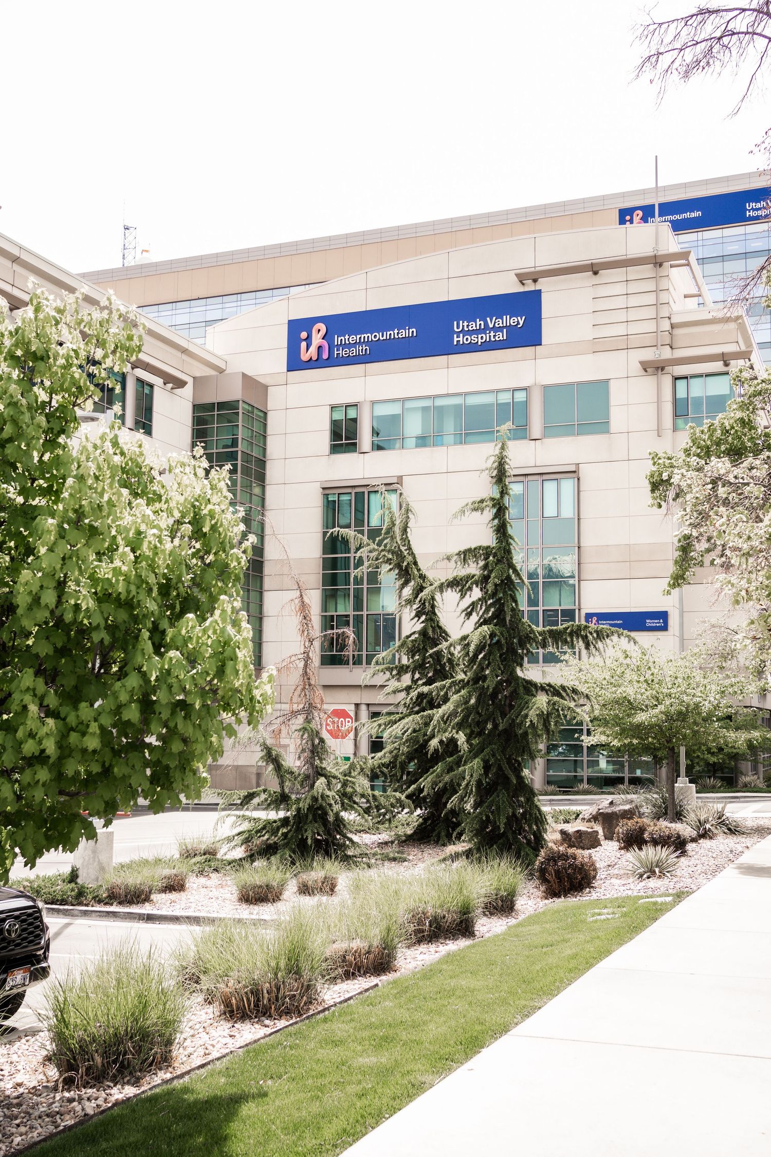 Exterior of Intermountain Health Utah Valley Hospital building with landscaped grounds.