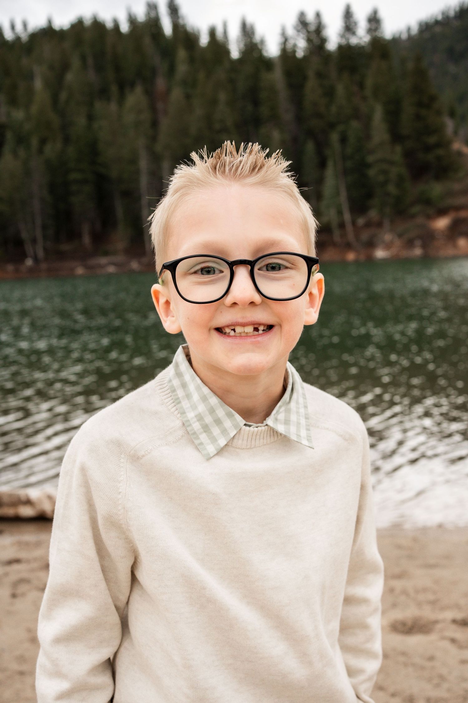 A sequence of close-up portraits showing joyful expressions by a lake with evergreen trees in the background.
