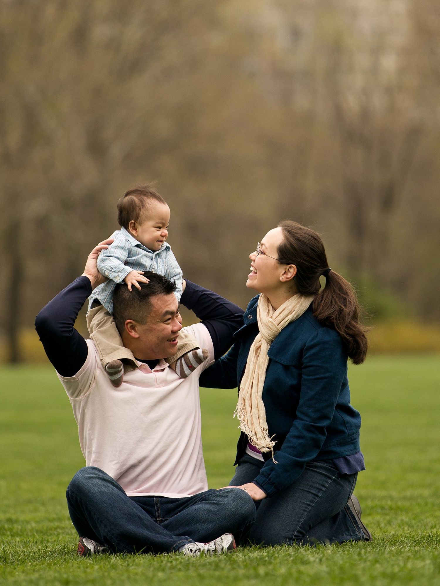 Couple relaxing together on grass in casual outdoor setting.