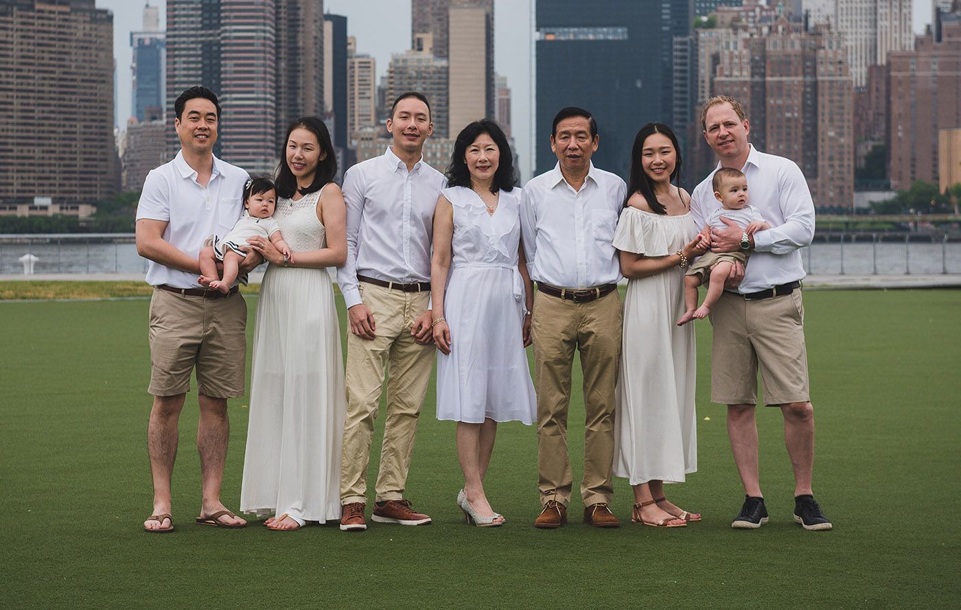 Family group photos with NYC skyline backdrop in casual summer attire.