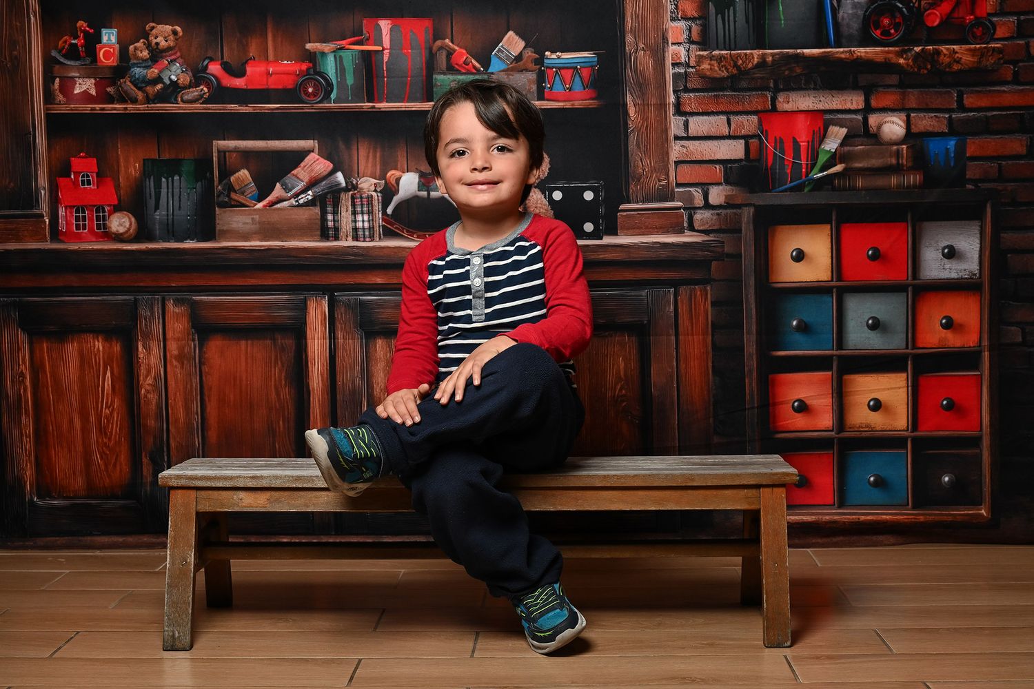 Modern studio photos with red wooden backdrop and colorful storage cubes.