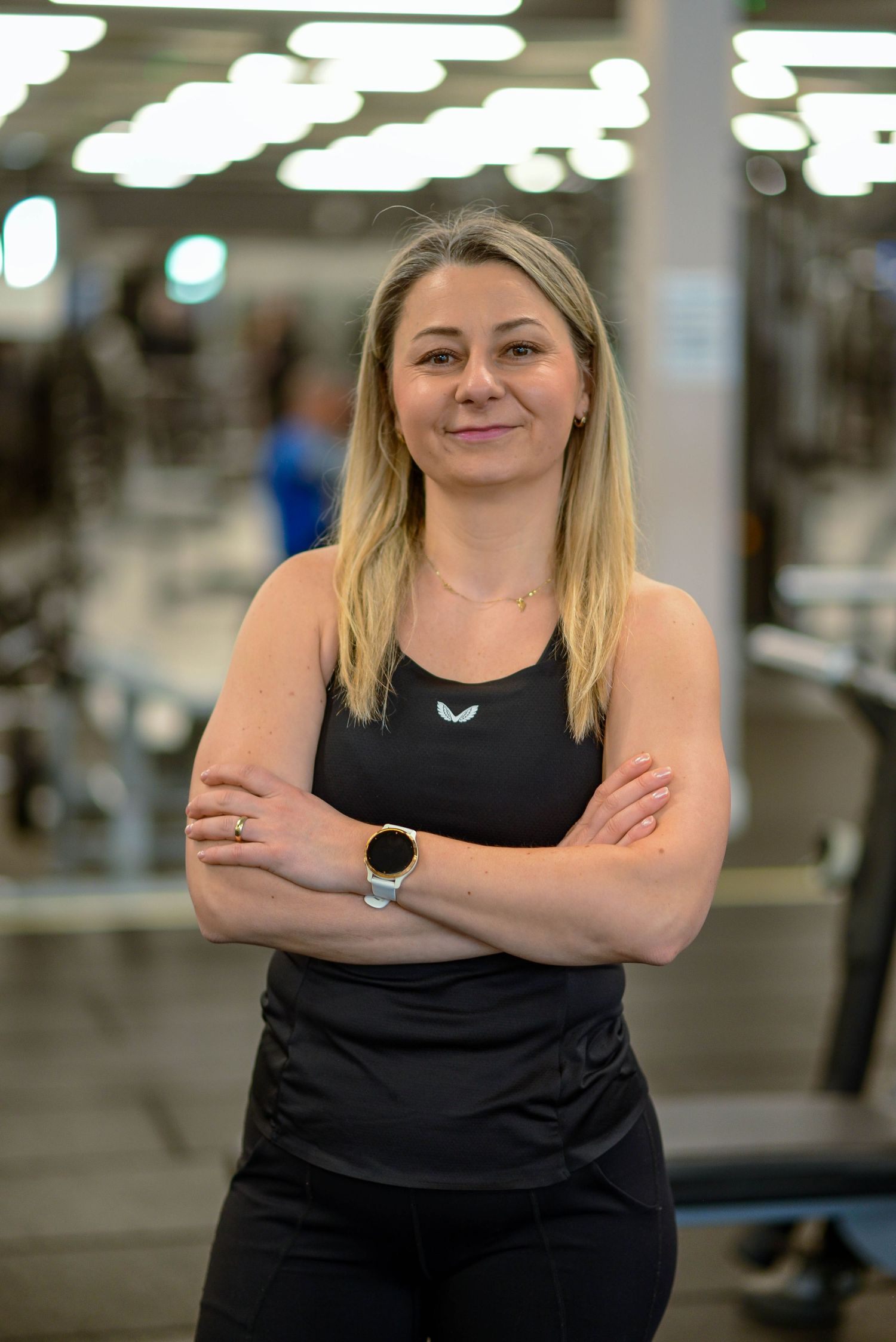 Glasgow portrait of a blonde-haired woman in a gym, wearing all black against a gym background