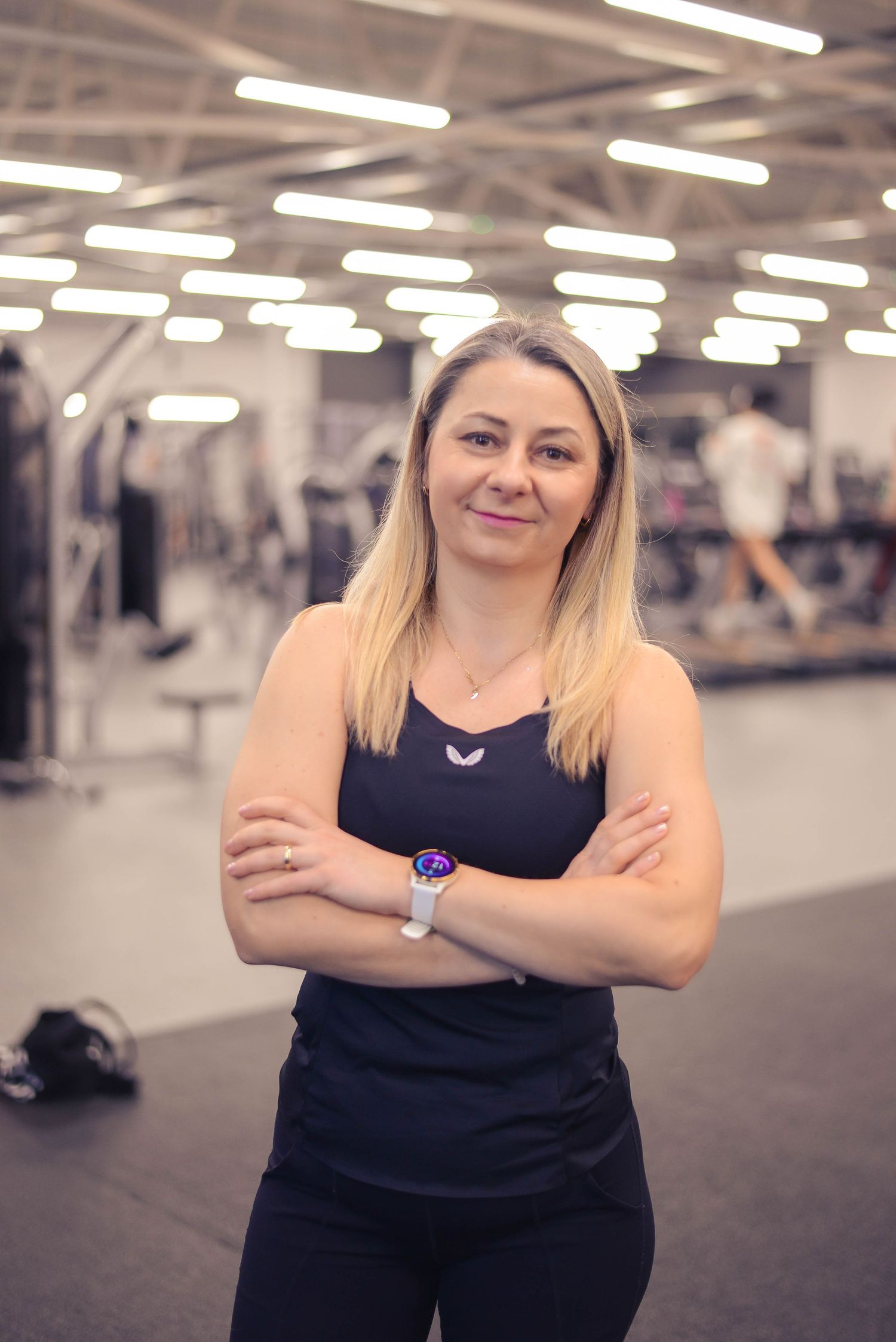 Glasgow portrait of a blonde-haired woman in a gym, wearing all black against a gym background