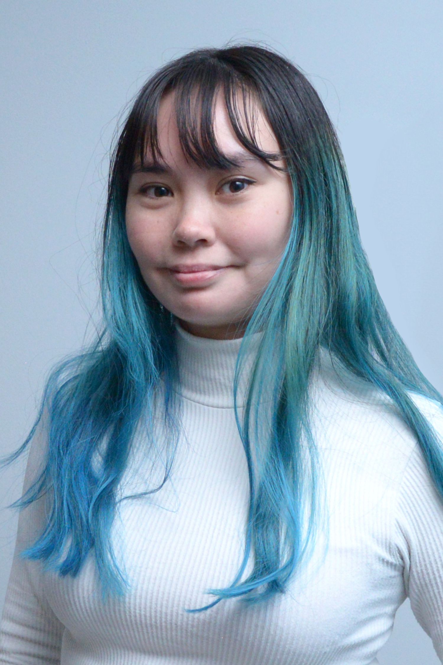 Glasgow corporate portrait of a blue-haired woman wearing a white top against a white-blue background