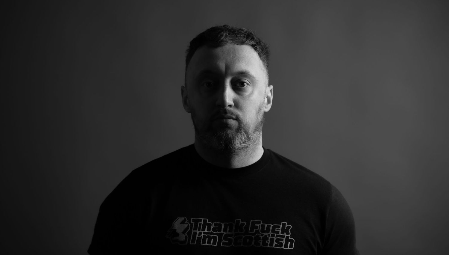 Glasgow black and white headshot portrait of a man against dark background
