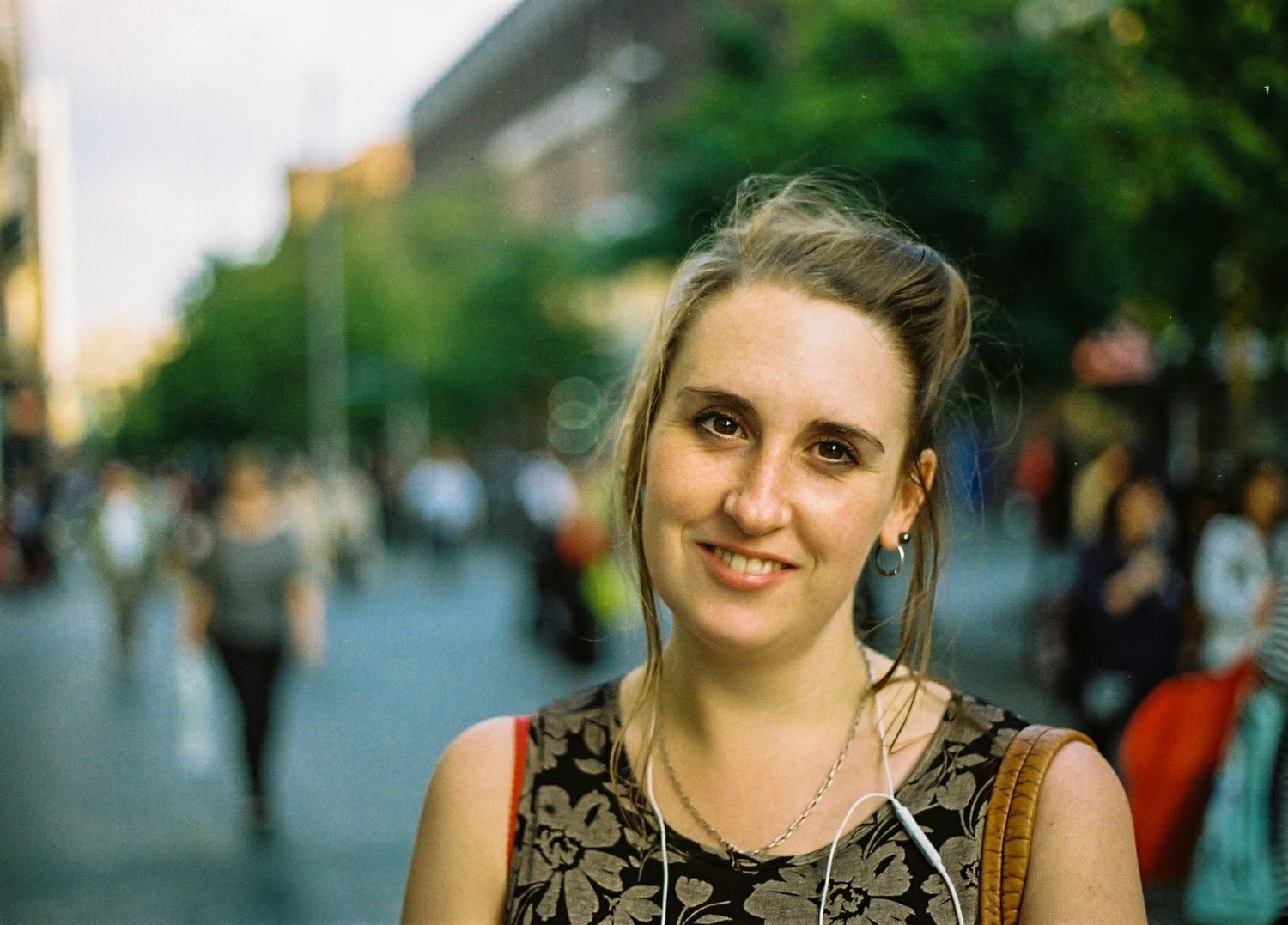 Glasgow corporate portrait of a smiling woman with light brown hair against a high street background