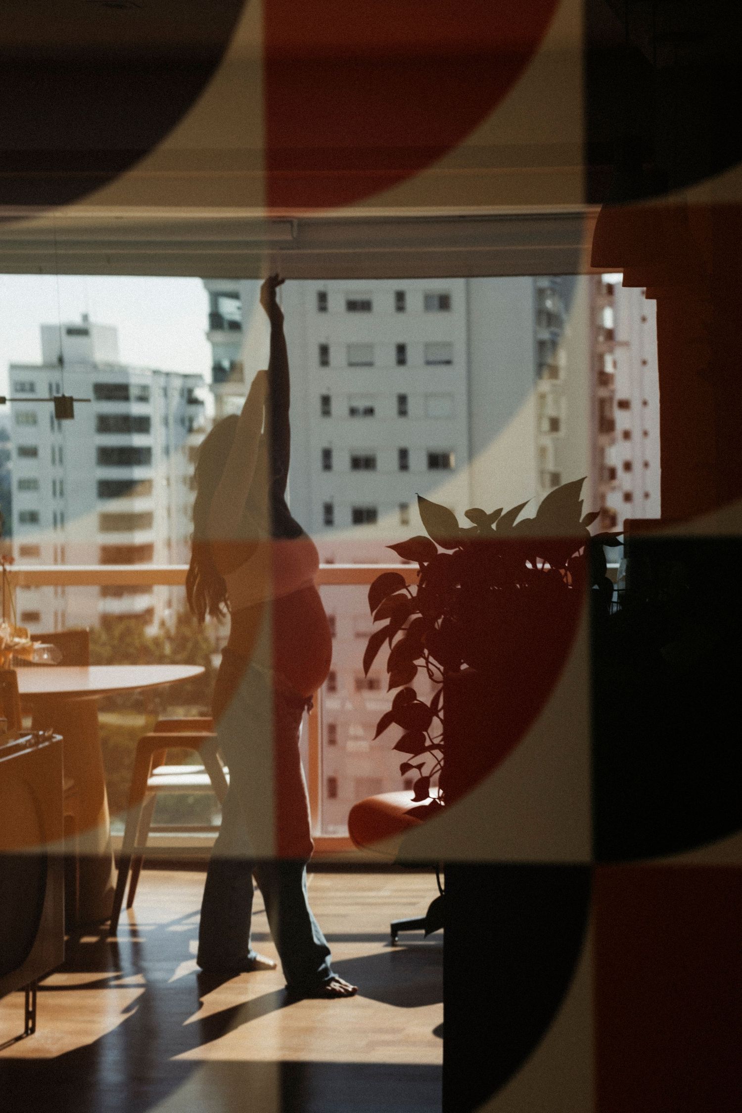 Silhouetted figures against urban apartment buildings at sunset.