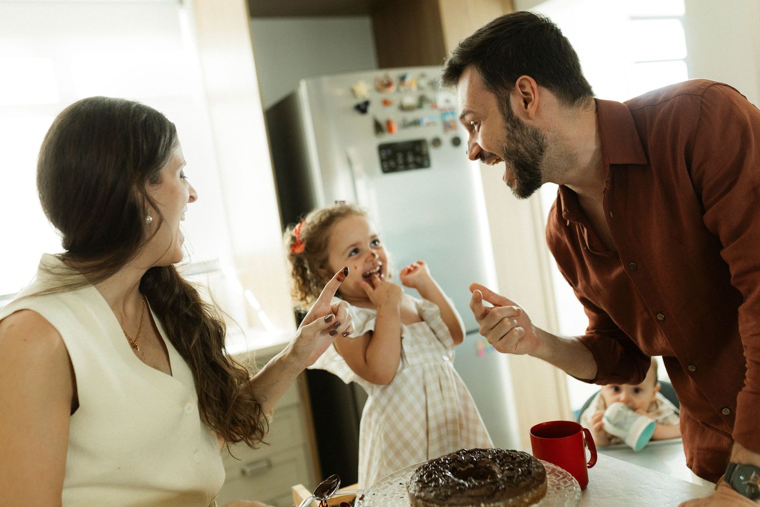 Candid indoor moments showing interaction between people in warm lighting.