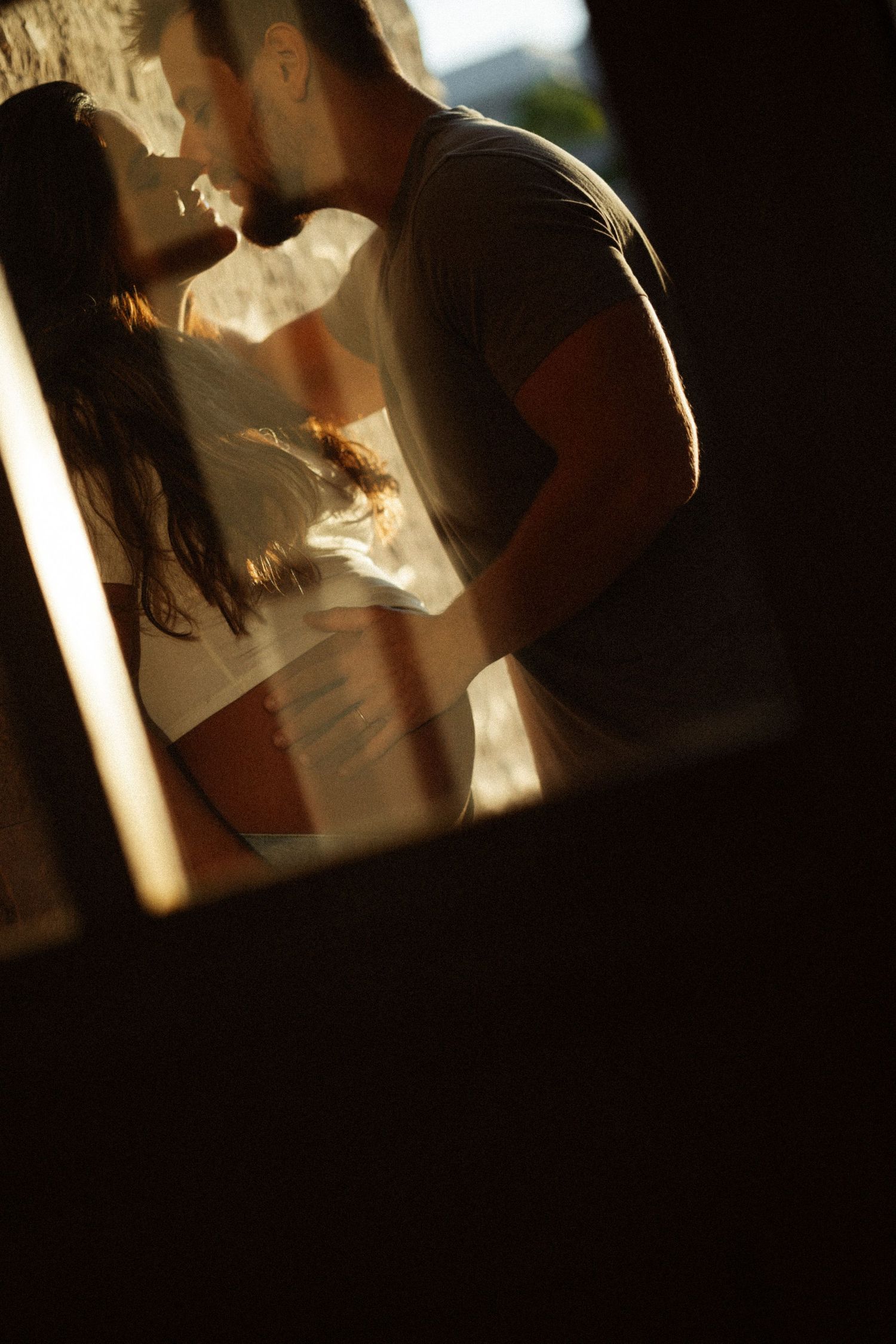 Artistic silhouette photography with dramatic natural lighting through windows.
