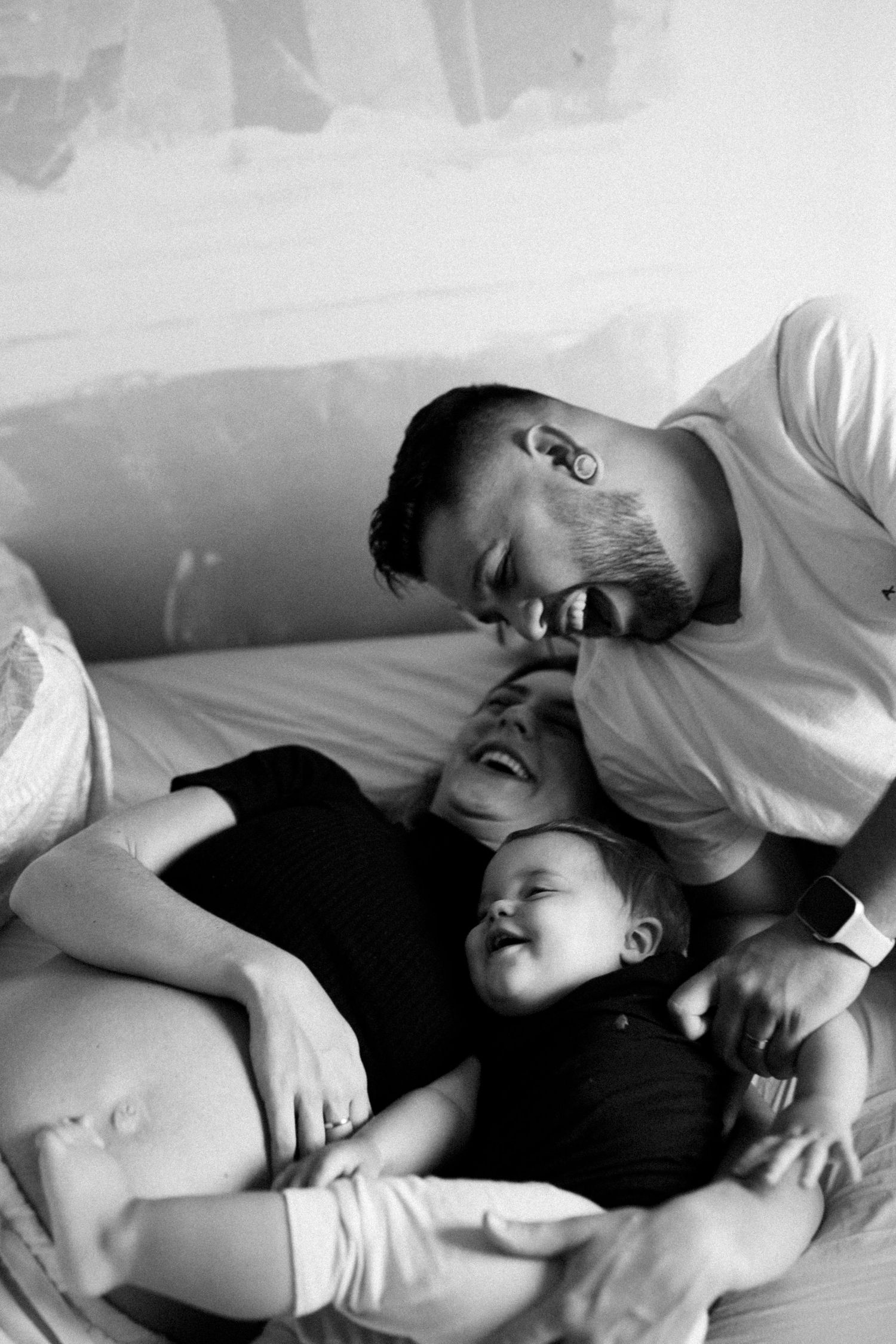 Intimate black and white sequence showing tender moments between two people laying down.