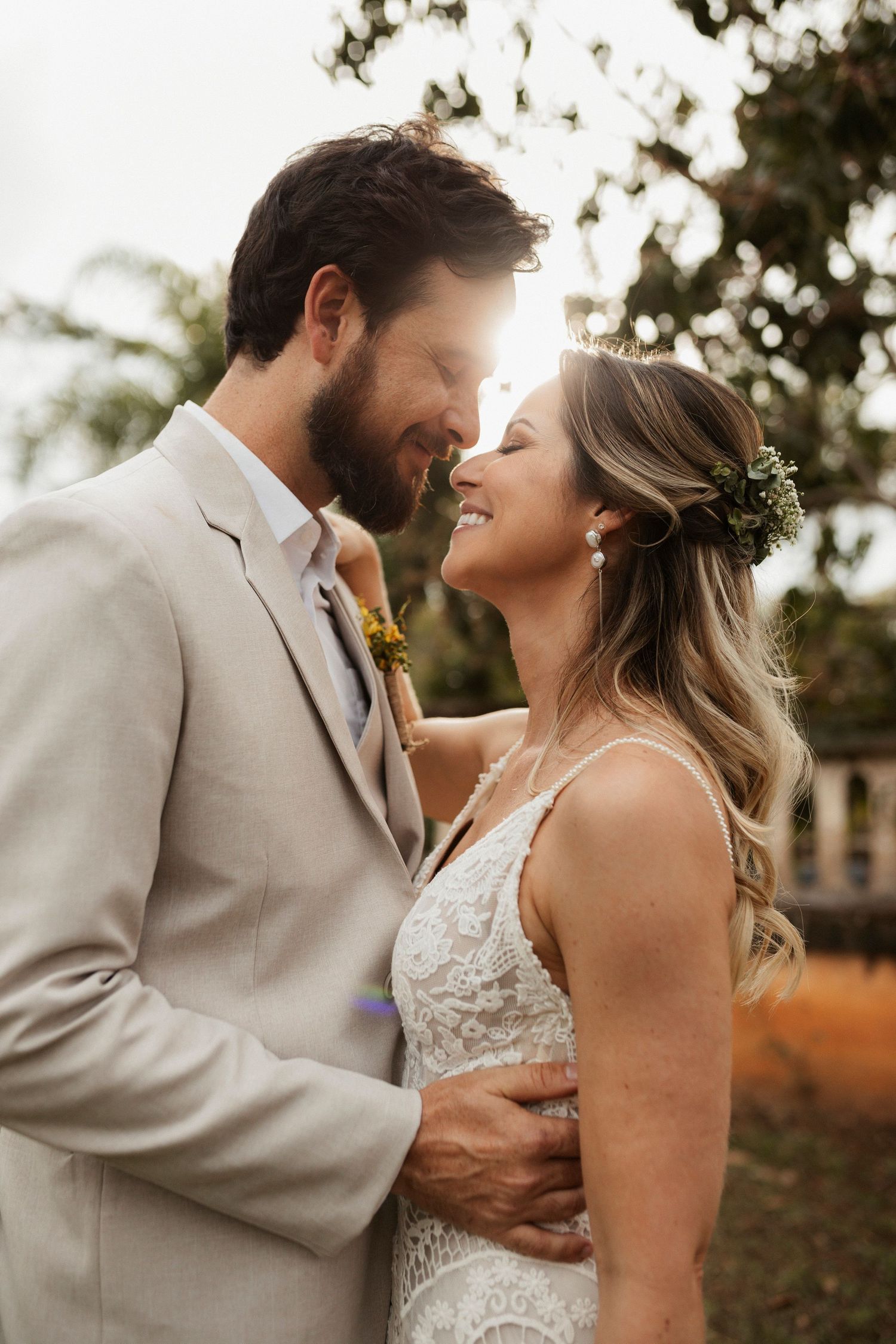 Romantic sunset portraits of newlyweds sharing intimate moments outdoors.