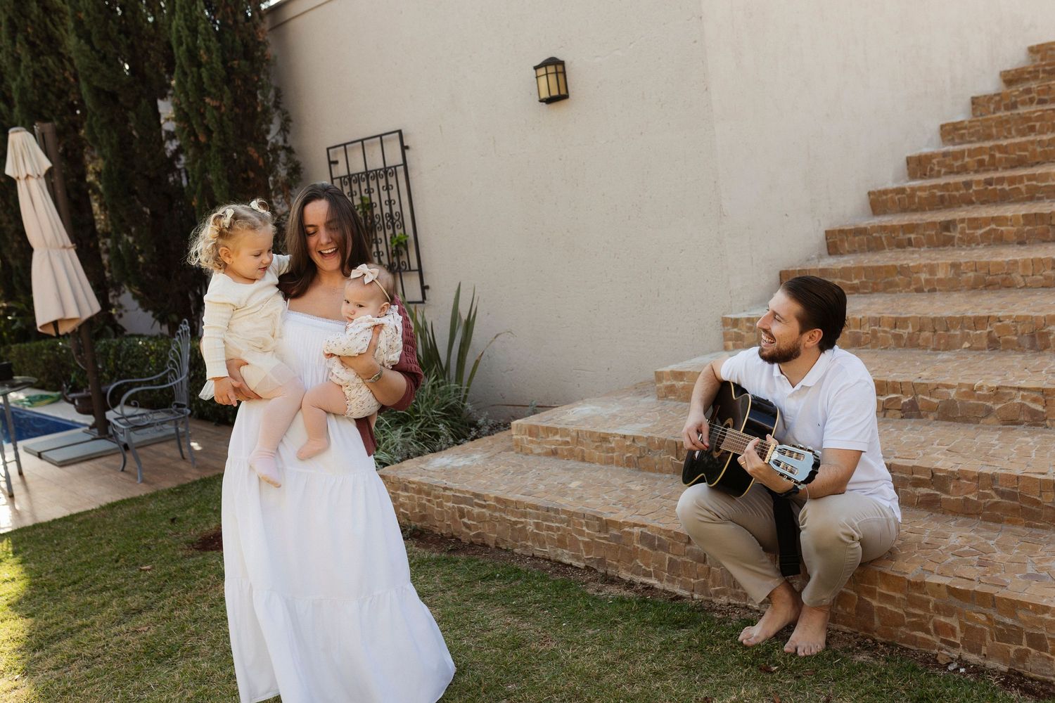 Family poses on rustic stone steps during an outdoor photo session.