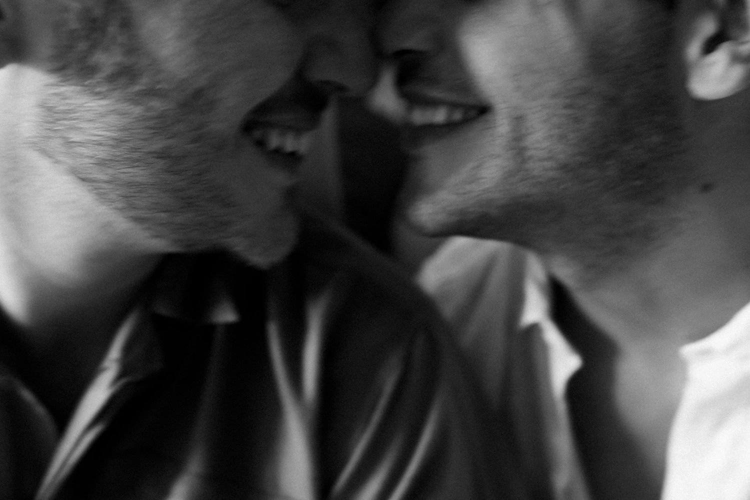 Black and white close-up of two people in an intimate moment.