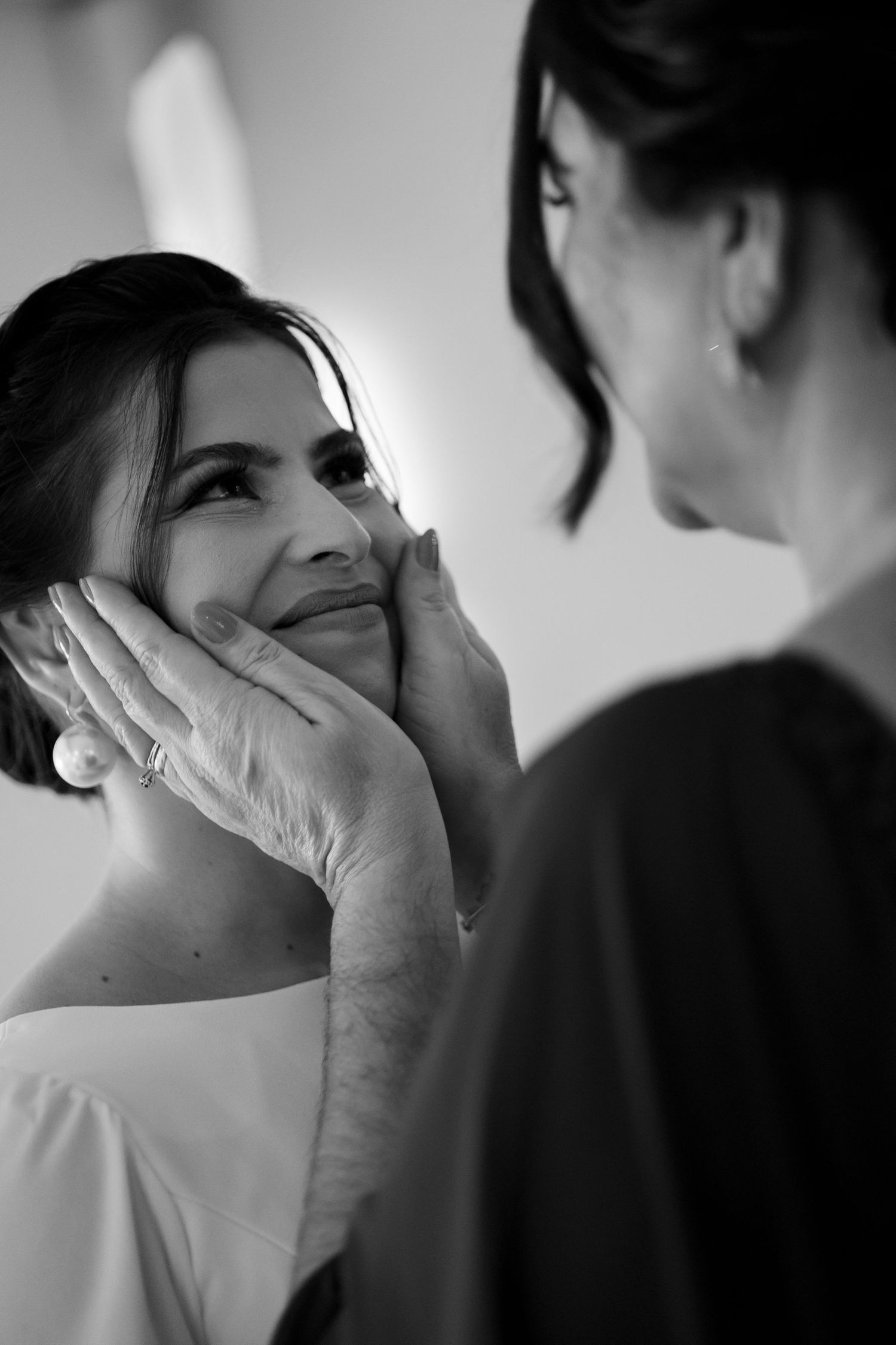 Emotional black and white wedding photography showing tender moments between couple.