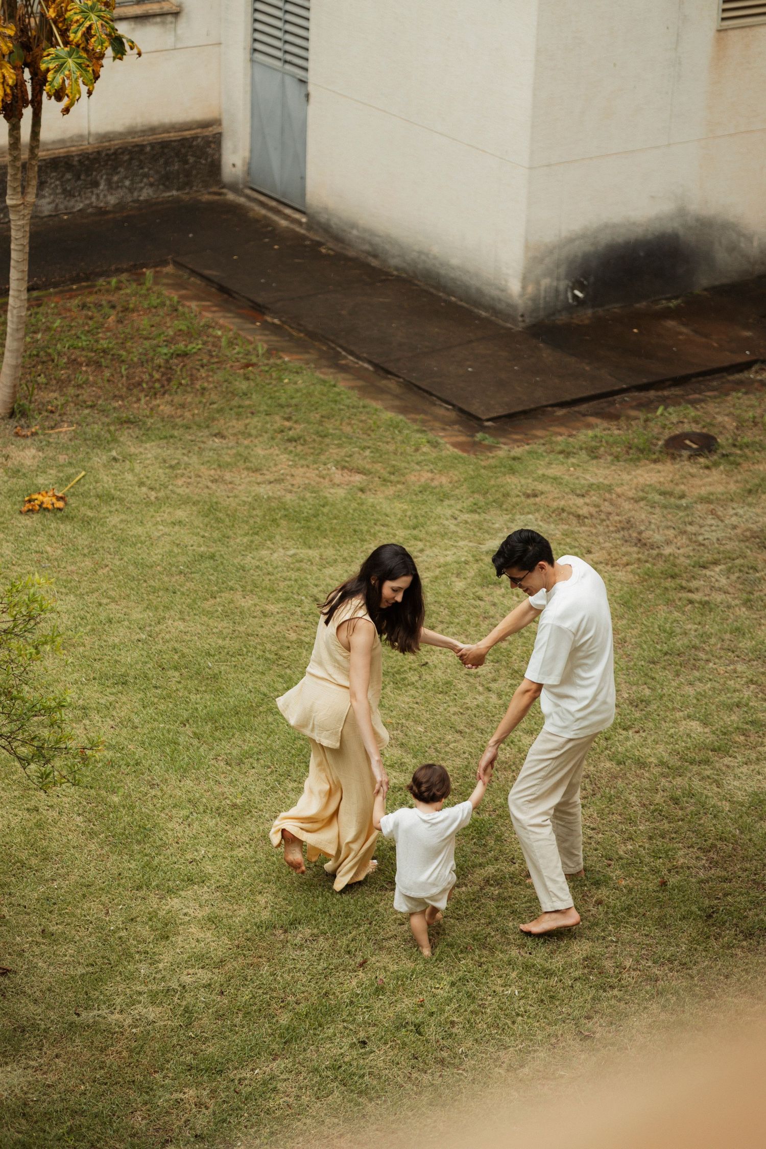 Sequence showing playful interactions between family members on a grassy lawn.