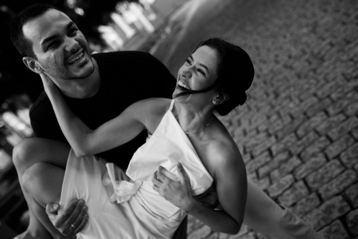 A romantic couple shares tender moments together in a series of black and white photographs.