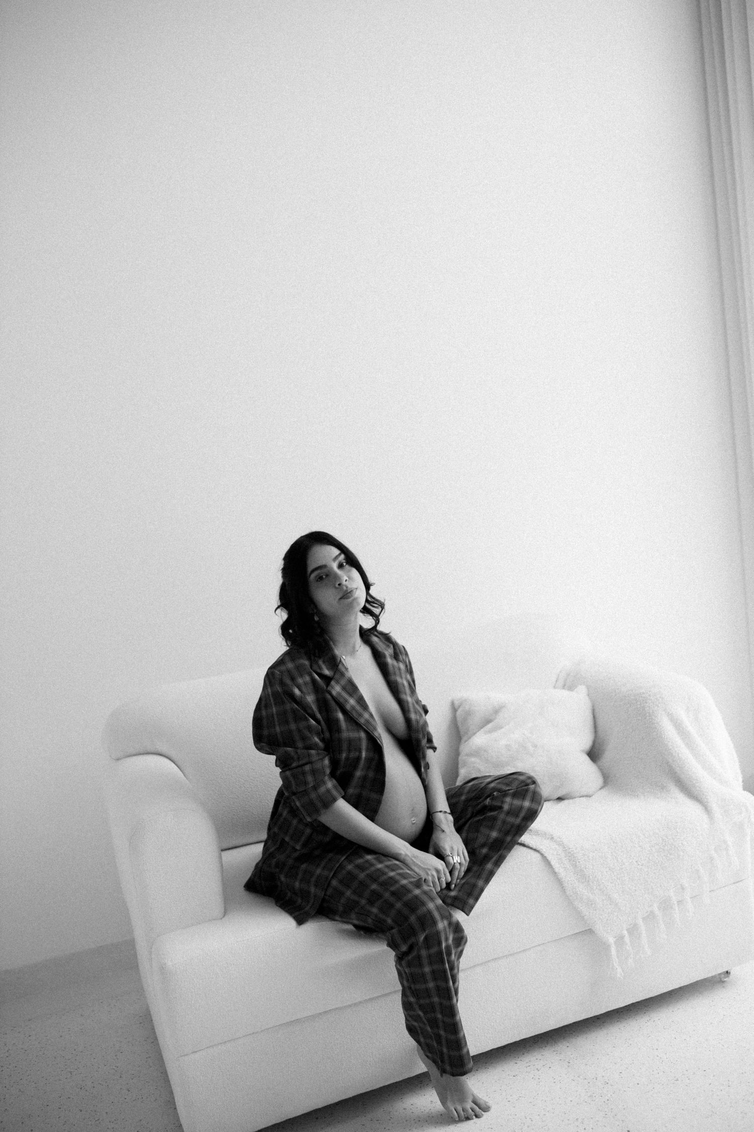 Black and white series showing relaxed poses on a white couch.