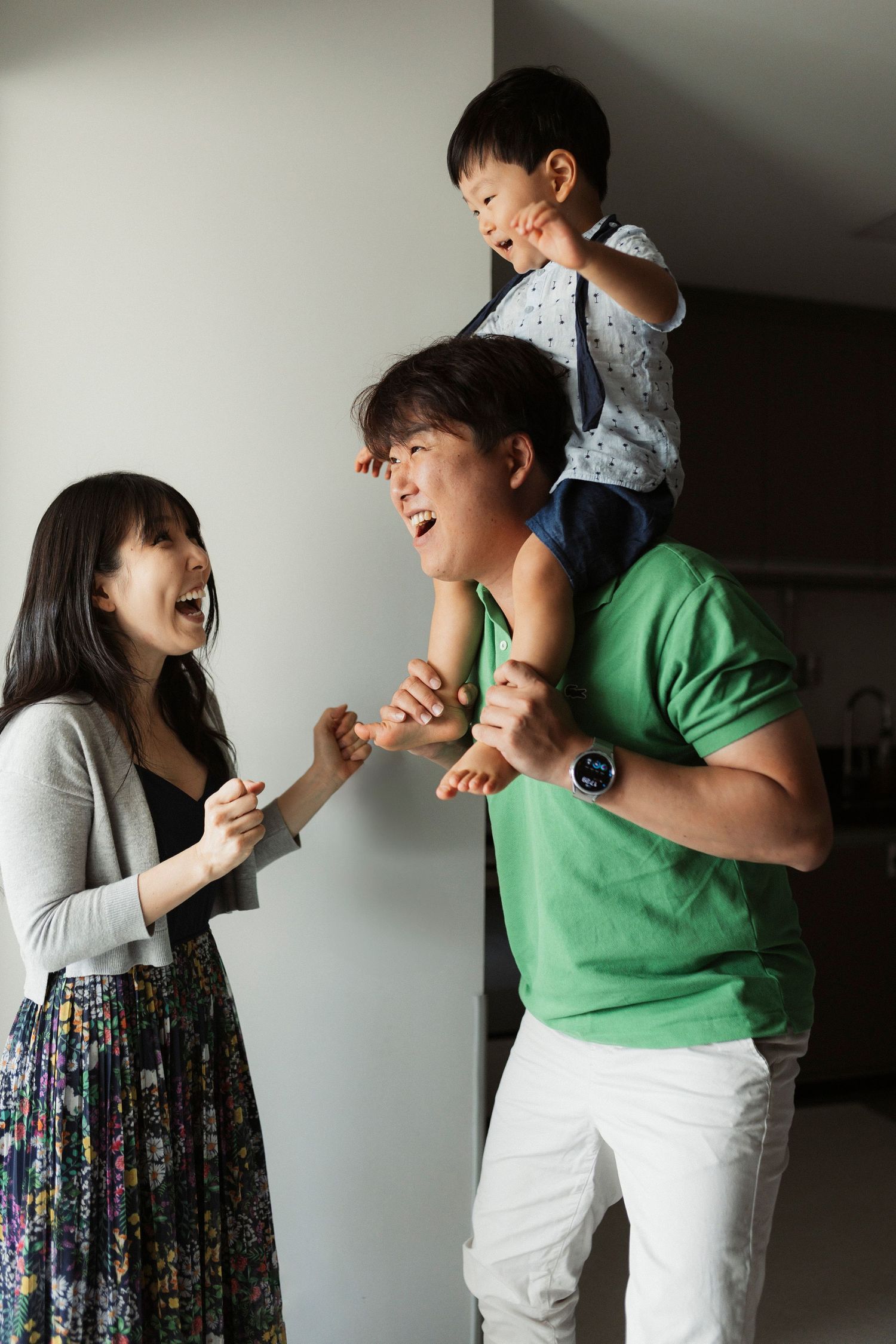 Candid sequence showing playful interactions and laughter between family members against a neutral background.