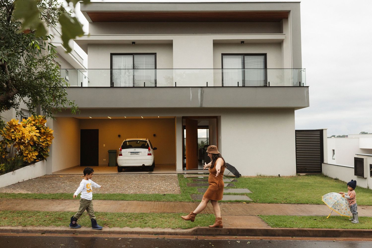 Modern white house exterior with clean architectural lines and grassy lawn.