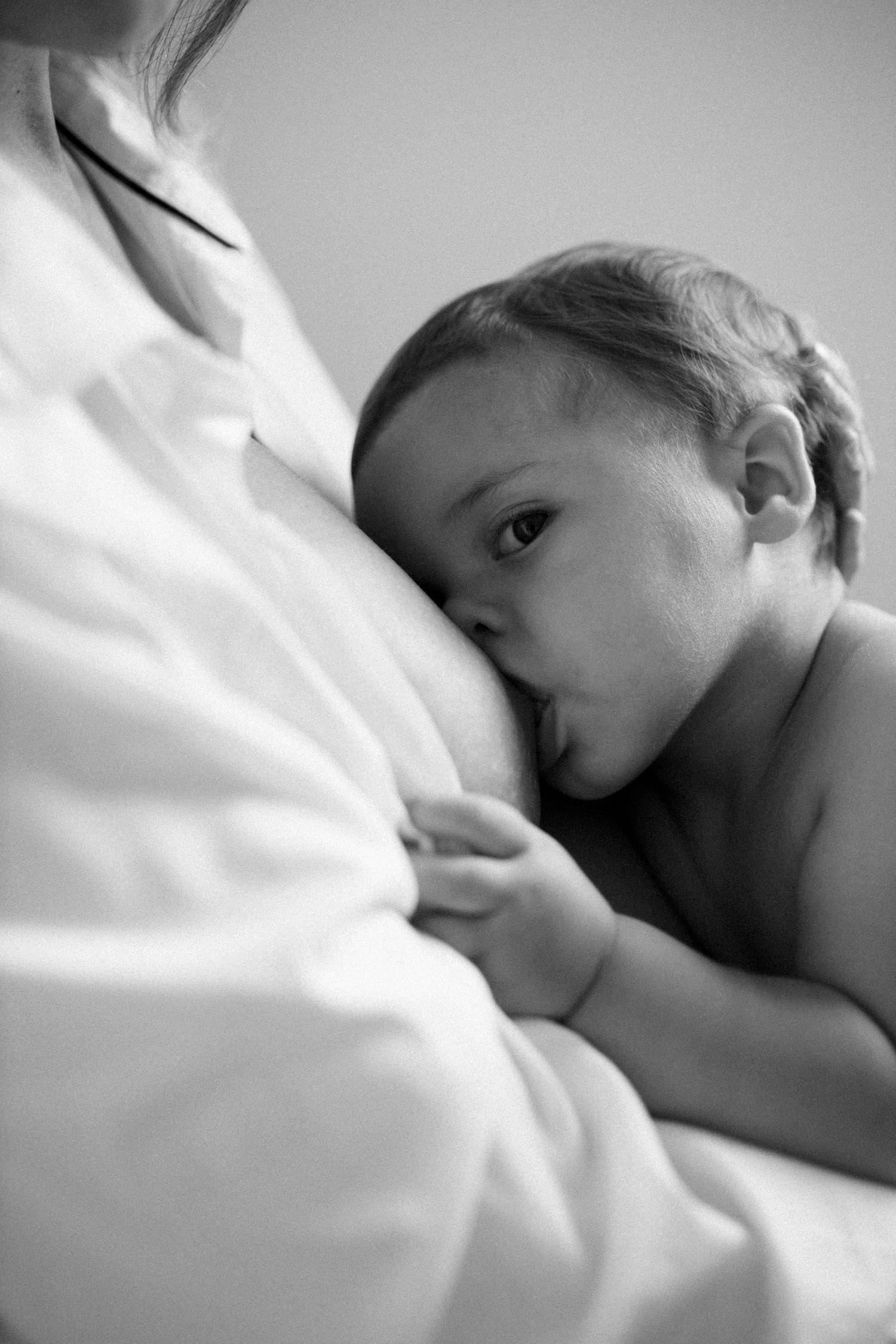 Close-up black and white series showing gentle intimate moments in soft lighting.