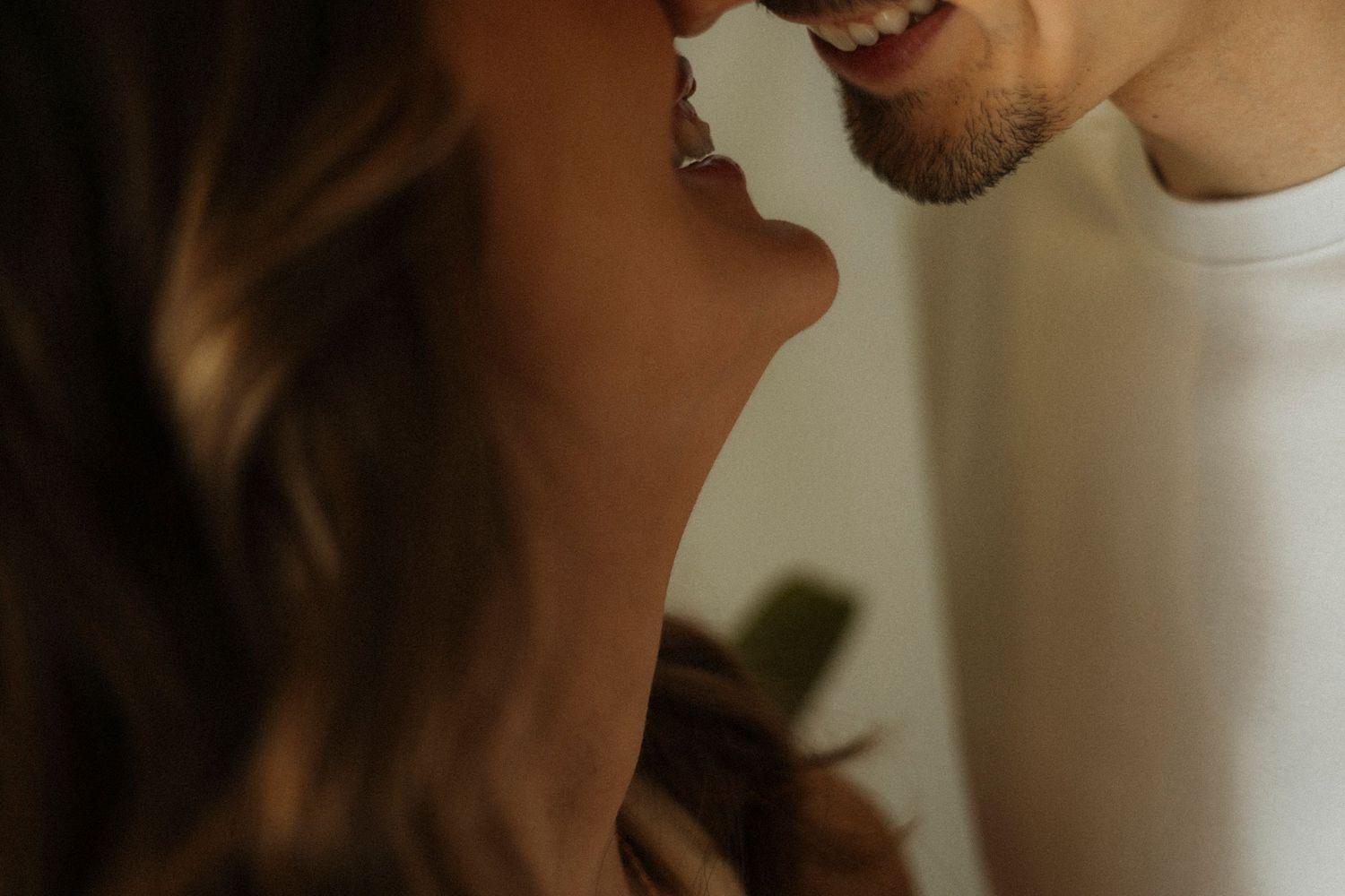 Close-up profile shot showing gentle smiles and intimate expressions.